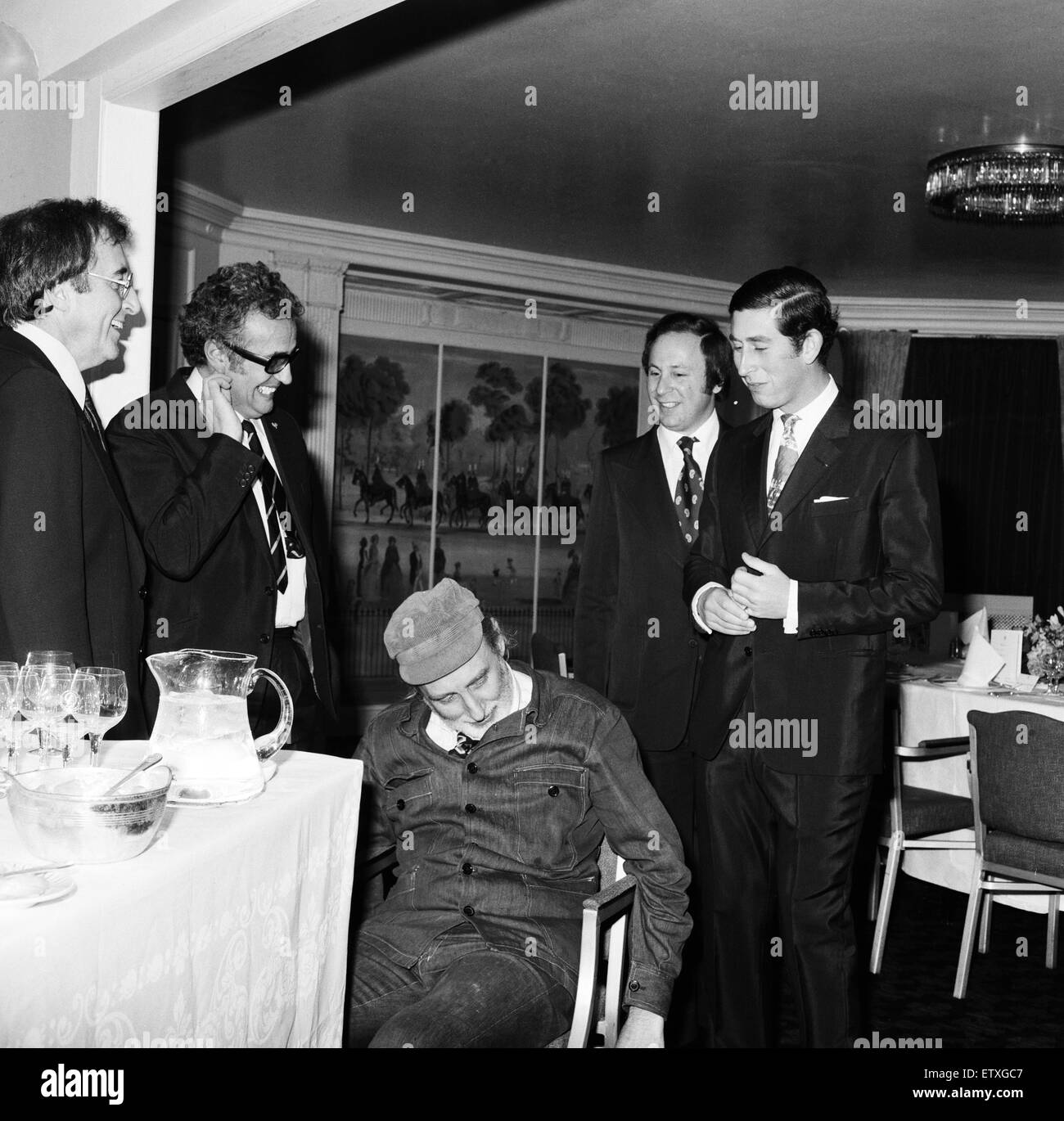 Prince Charles dines with The Goons at The Dorchester, London. Spike Milligan, Peter Sellers and Michael Bentine greeted the Prince's arrival with cries and jokes. (Harry Secombe was at home ill). The Prince walks over to the Goons with Spike Milligan in Stock Photo