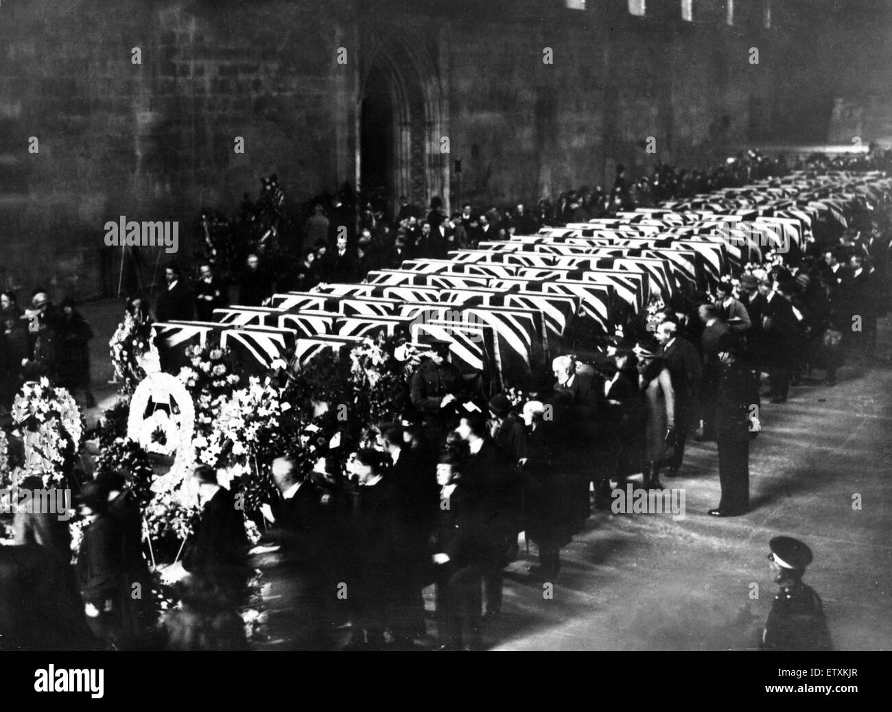 The sad and impressive scene at historic Westminster Hall when the coffins of the forty-eight men killed in the R101 disaster lay in honoured state. As officer and men of the R.A.F., the latter with arms reversed, kept motionless guard beside the biers, a Stock Photo