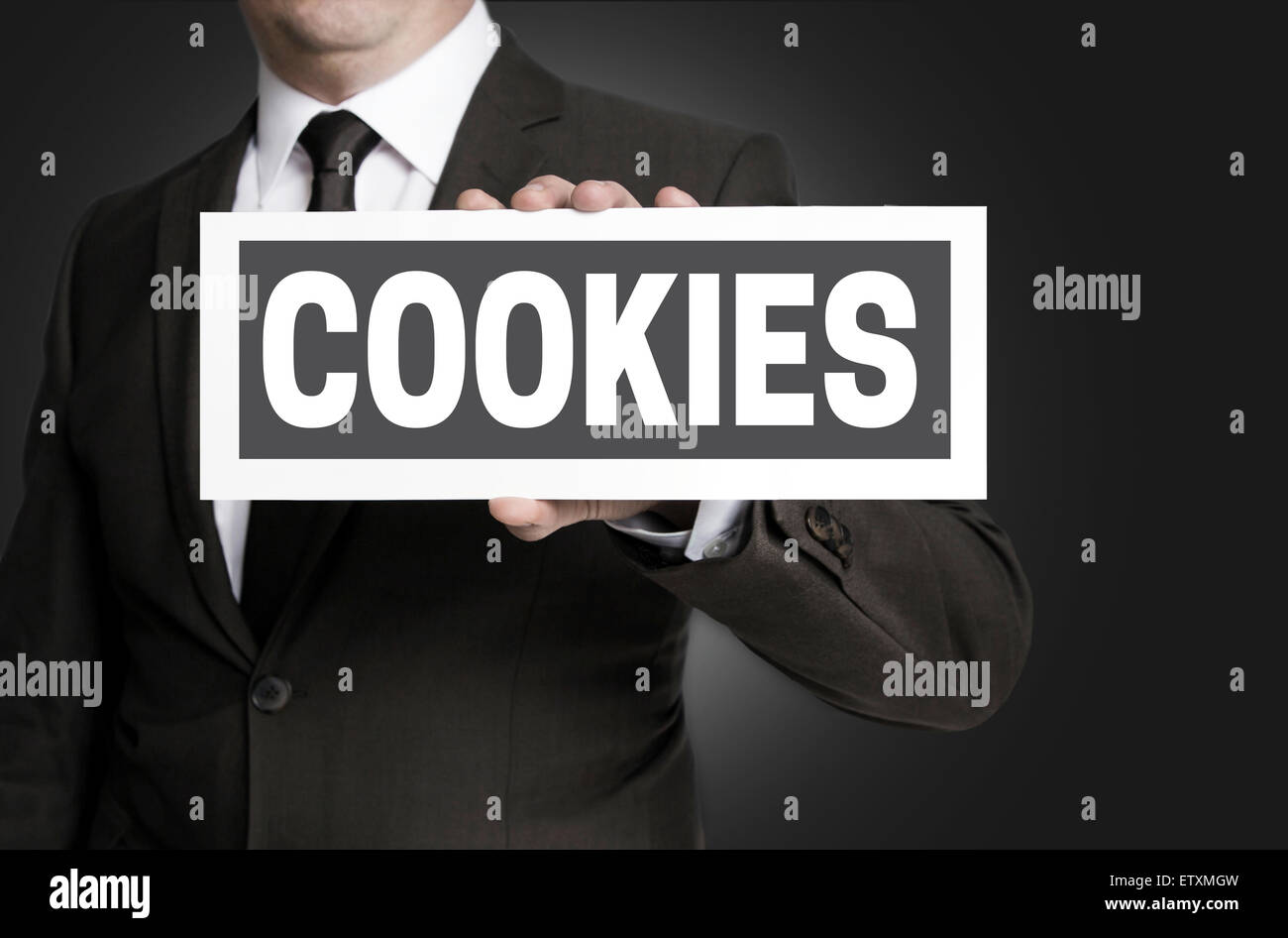 Cookies plate is held by businessman. Stock Photo