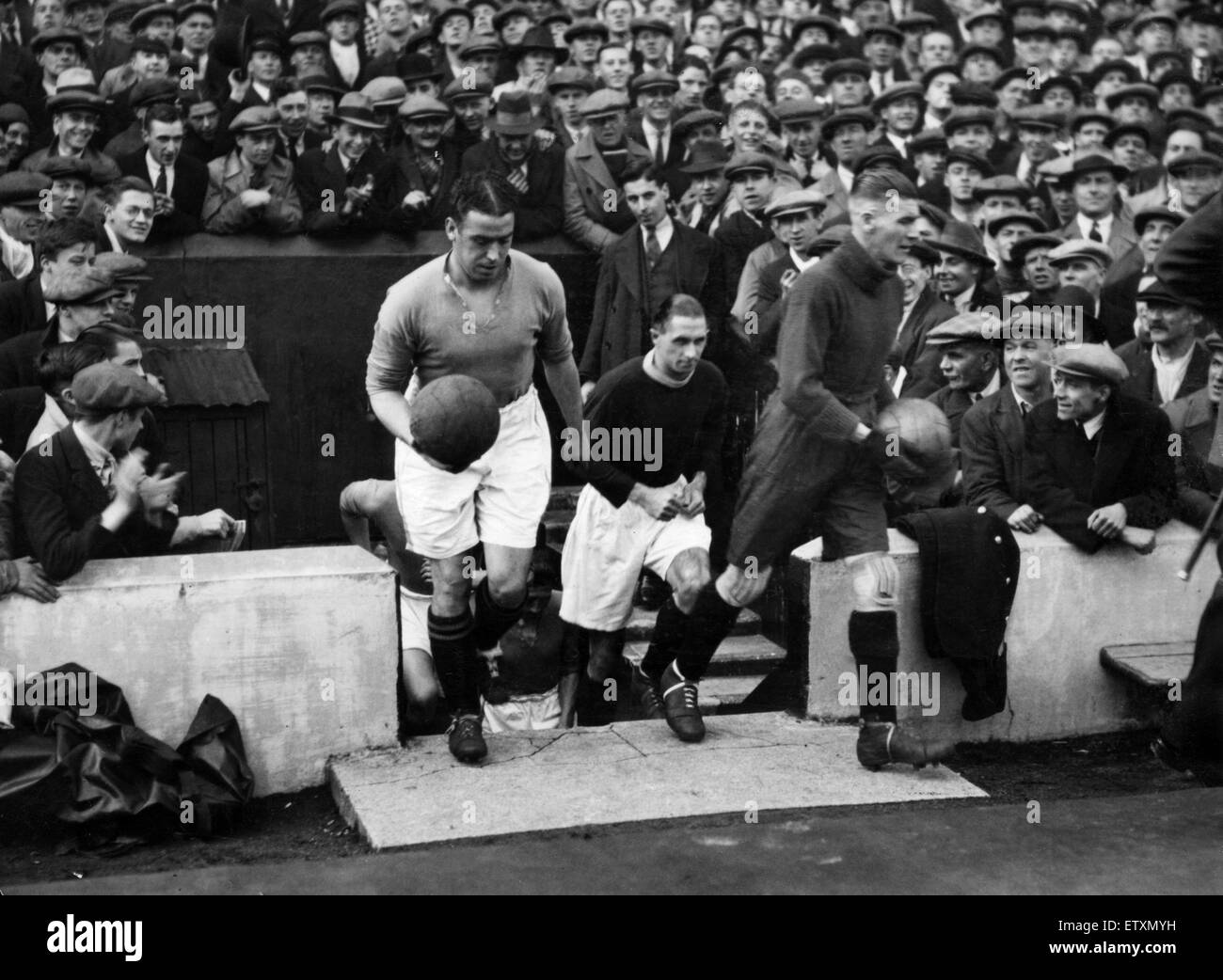 English League Division One match between Merseyside rivals Liverpool and Everton. Everton captain  William 'Dixie' Dean walks out on to the pitch with his rival Elisha Scott, goalkeeper and captain of Liverpool, before the Merseyside derby match. Circa 1 Stock Photo