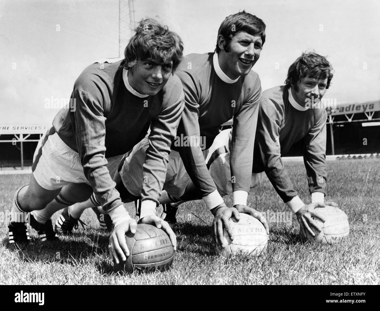 Wrexham F.C's new signings Andy Provan (right) and Tommy Vansittart limber up during a training session with captain Eddie May, before the clubs first season in the league Division III. 24th July 1970. Stock Photo