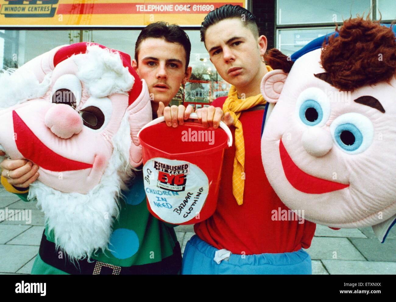 Simon Gray, right, and Mark Bowler, after they were mugged and their charity bucket, full of money, was stolen. They are pictured with their Noddy and Big Ears heads and one of the buckets used to do their collecting for Children in Need. 4th November 199 Stock Photo