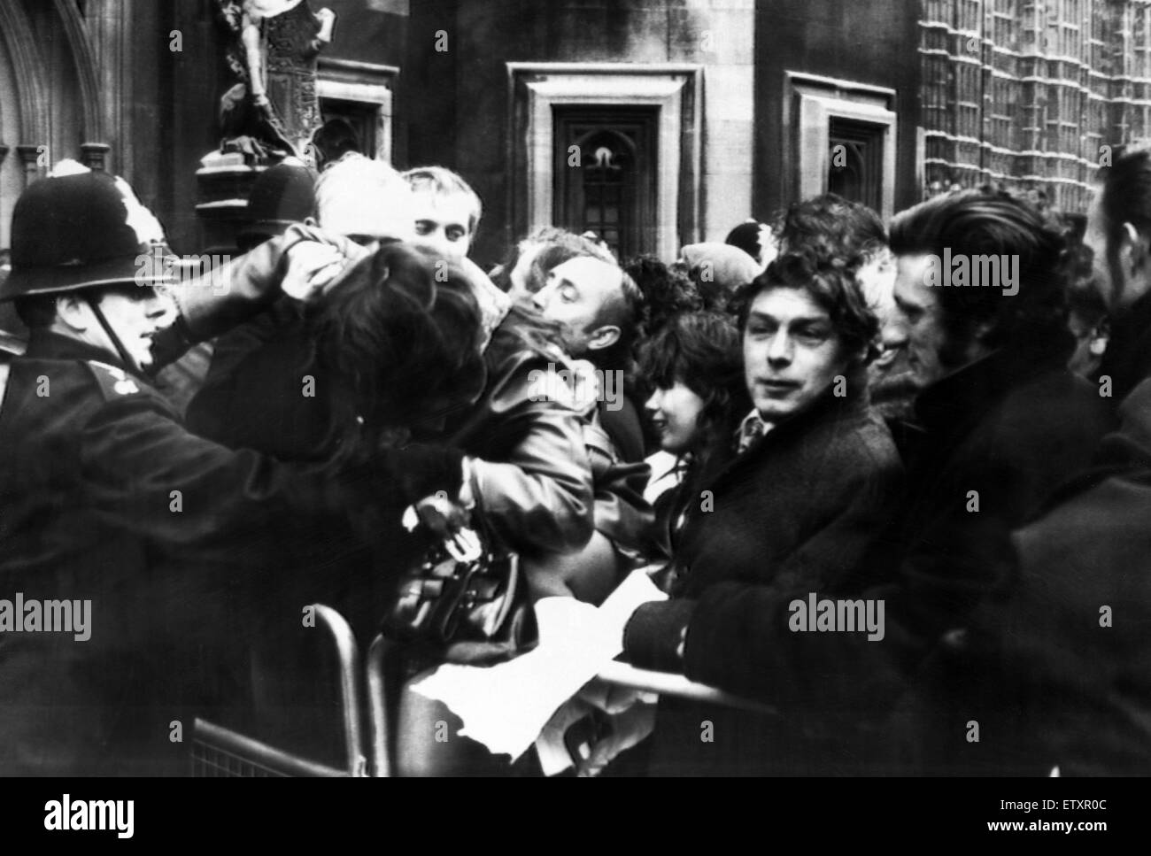 1972 Miners Strike. Demonstration outside House of Commons, London, Friday 18th February 1972. The demonstrators from a number of unions and students massed outside the commons in an attempt to lobby MPs. Pictured, Demonstrators help a policeman to lift a Stock Photo