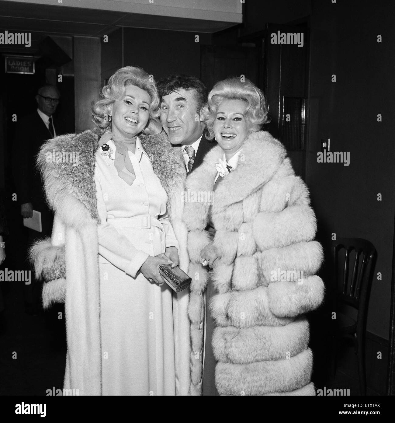 Frankie Howerd, took the two Gabor sisters Eva and Zsa Zsa, out for a different evening's entertainment watching greyhound racing at White City. The trio arrive at the top floor restaurant.  25th March 1972. Stock Photo