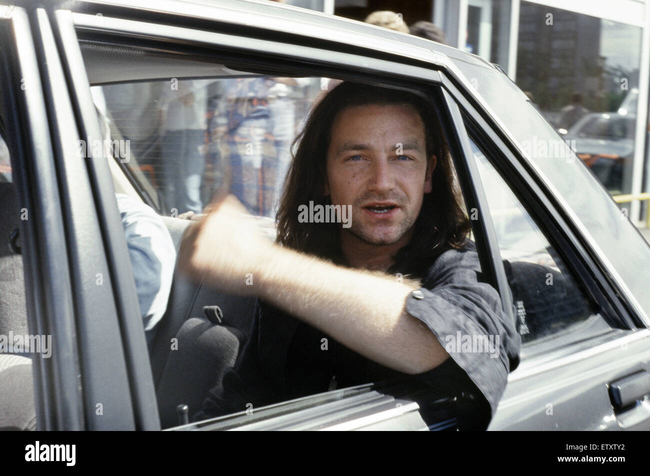 Bono, lead singer of Irish Rock group U2, pictured upon arrival in Glasgow, Scotland ahead of the band's next concert on their Joshua Tree tour to be held at the SECC, Glasgow. July 1987 Stock Photo