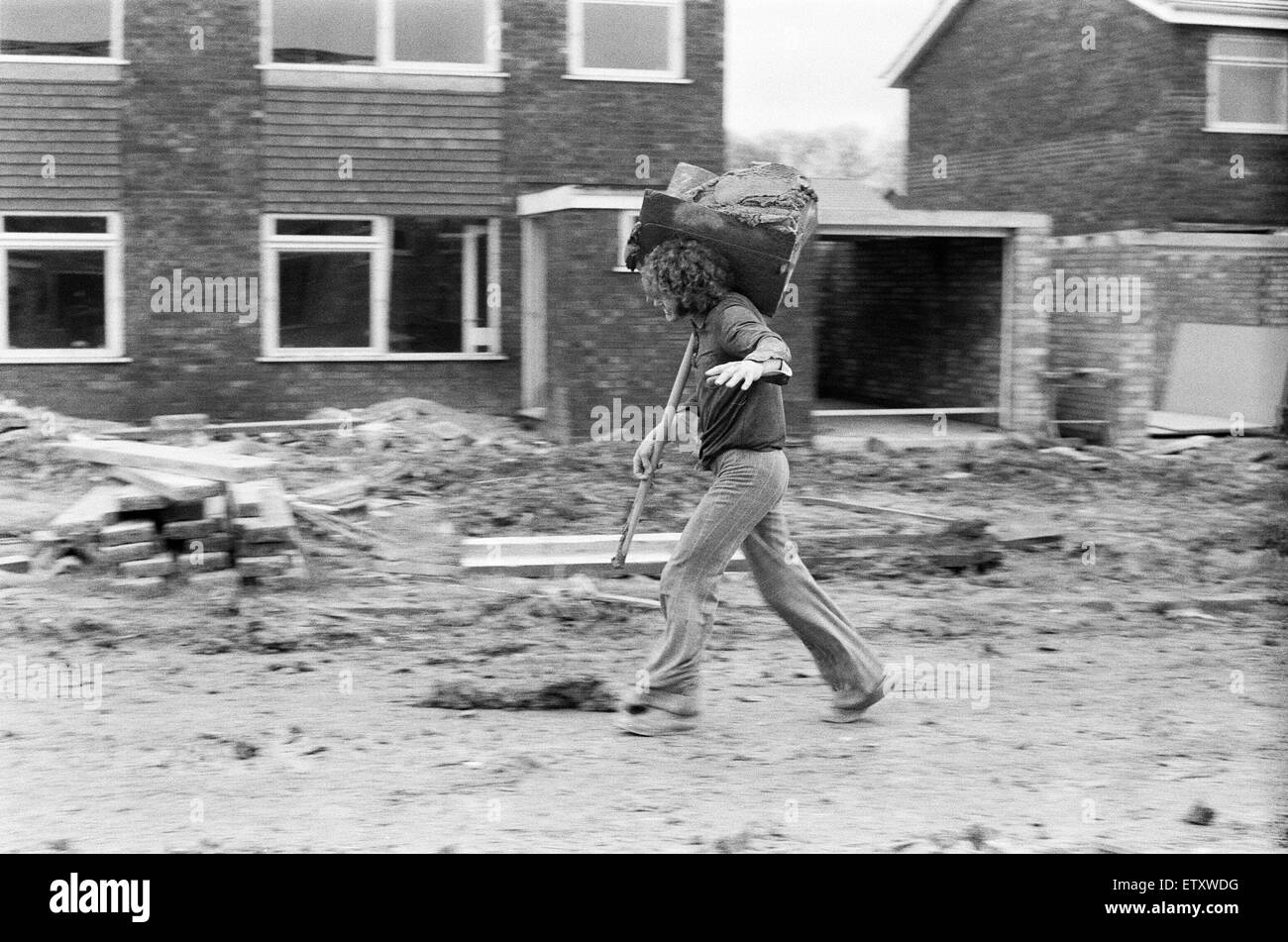 Max Quarterman, the 33 year old plasterer's mate who earns up to £400 a week, pictured carrying his hod on a building site at Hazelmere near High Wycombe, Buckinghamshire. 6th January 1975. Stock Photo