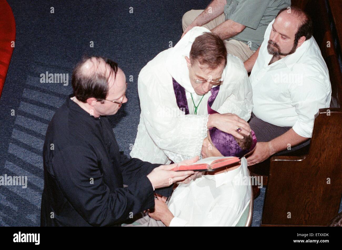 William Ramsey from Southend-on-Sea in the UK being exorcised by Bishop Robert McKenna at 'Our Lady of the Rosary Chapel' in Monroe, Fairfield County, Connecticut, USA. 28th July 1989. Stock Photo