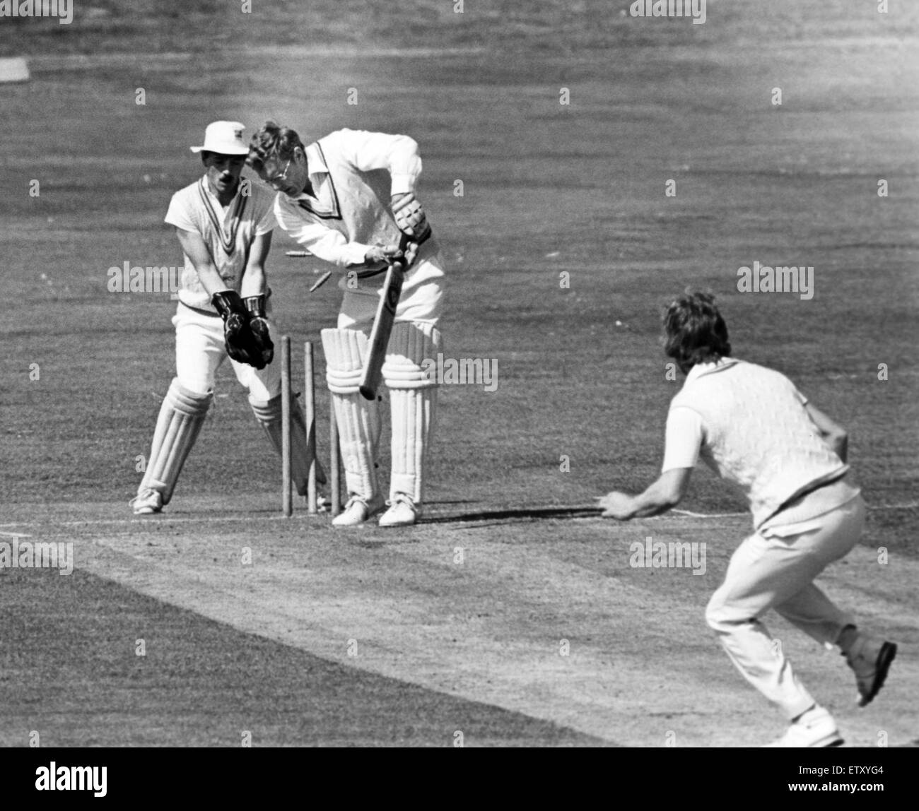 The bails are sent flying as Hartlepool pace bowler Tommy Fountain dismisses Guisborough batsman Graham Street with wicket keeper Des Playfor looking on. 14th May 1984. Stock Photo