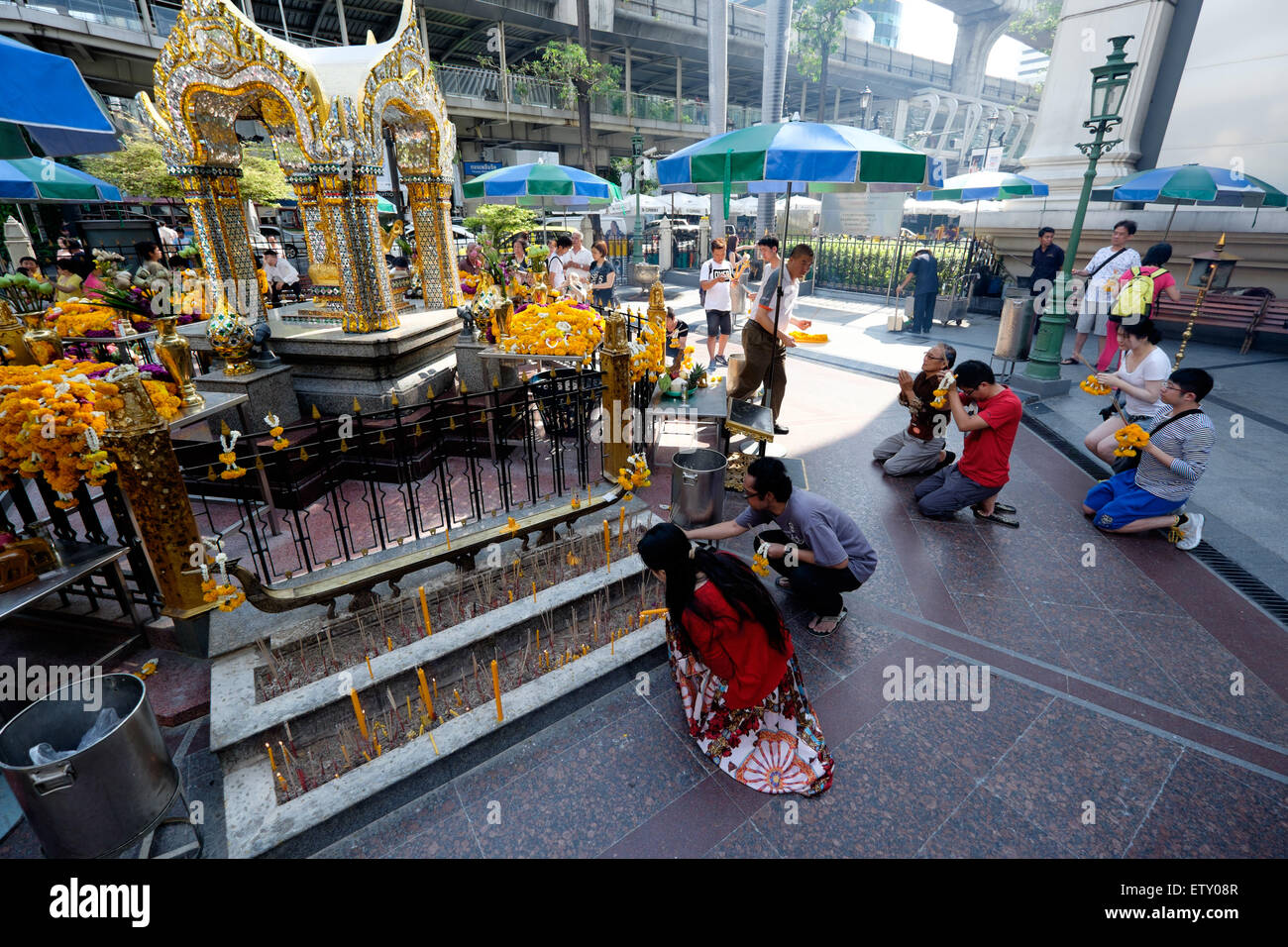 Local temple in Bangkok, Thailand.  Many locals and tourists come here to worship and offer flowers to the deities Stock Photo
