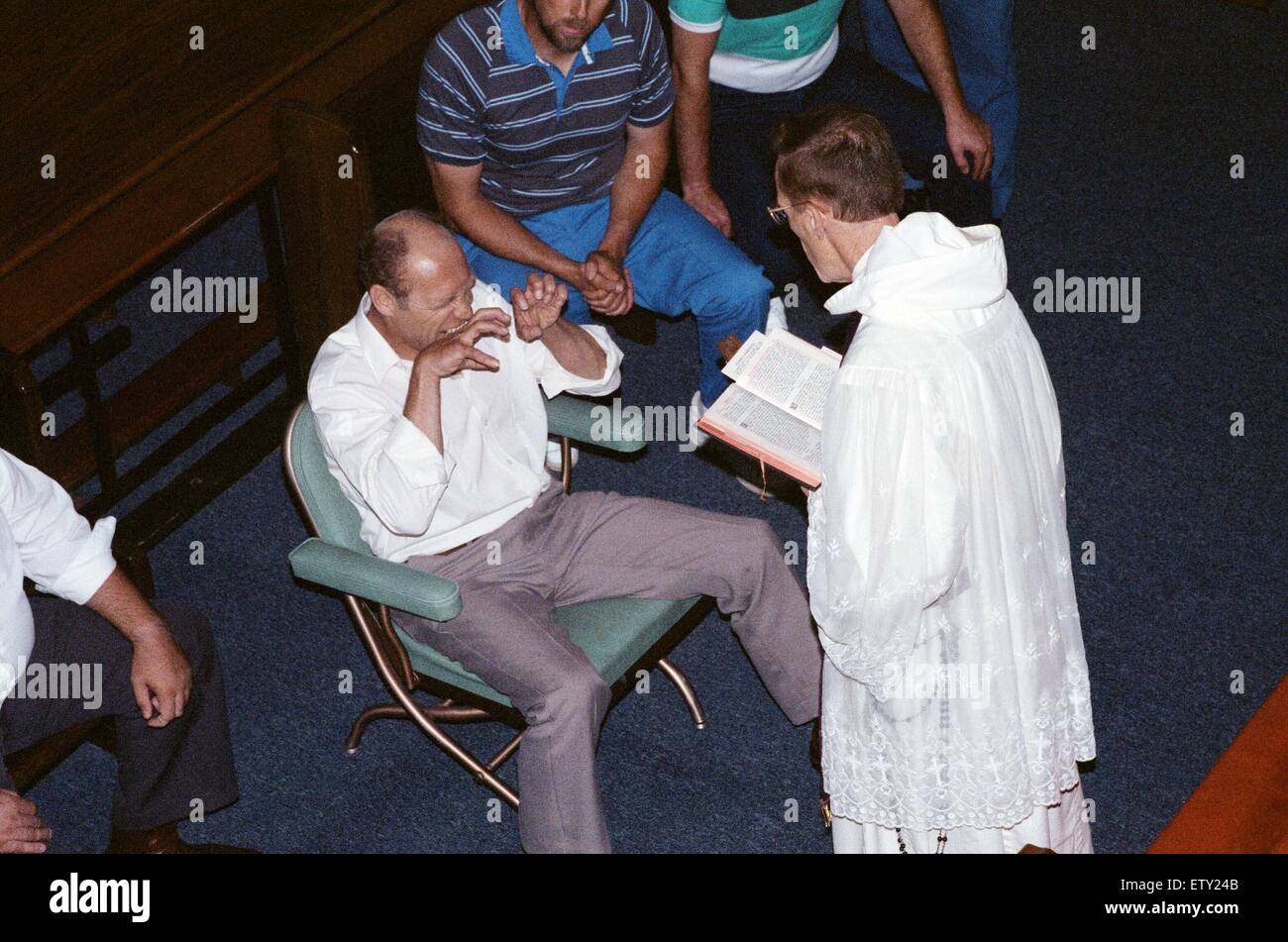 William Ramsey from Southend-on-Sea in the UK being exorcised by Bishop Robert McKenna at 'Our Lady of the Rosary Chapel' in Monroe, Fairfield County, Connecticut, USA. 28th July 1989. Stock Photo