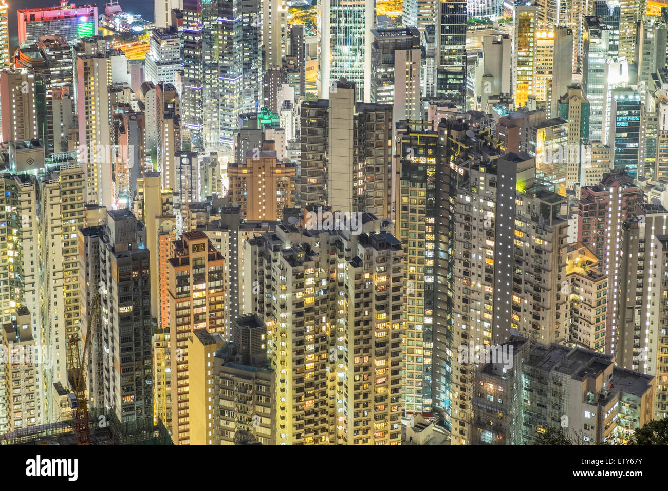 Night view of many high-rise apartment buildings in dense urban district of Hong Kong China Stock Photo