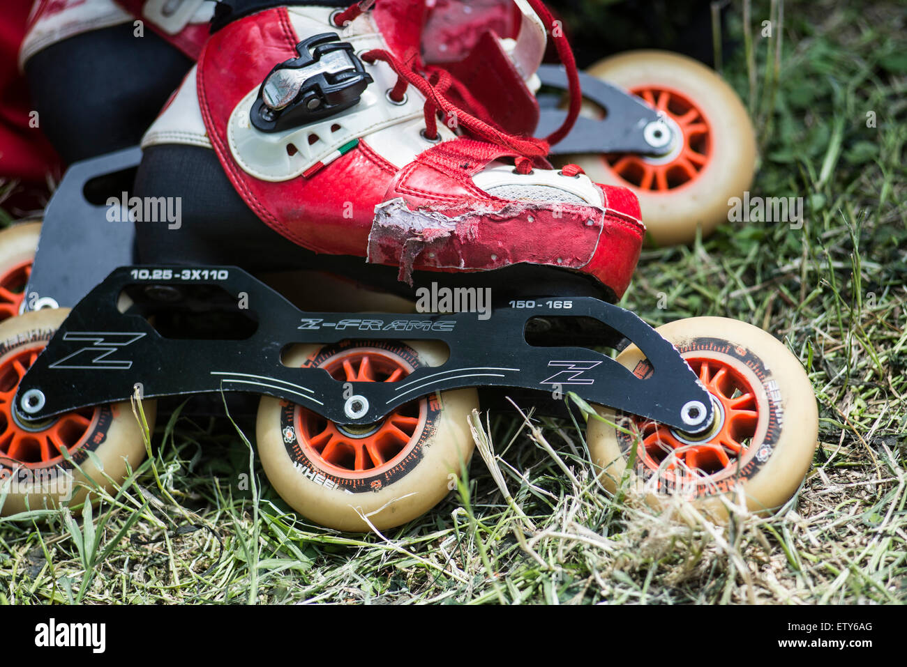 Red speed inline skates with three wheels Stock Photo Alamy