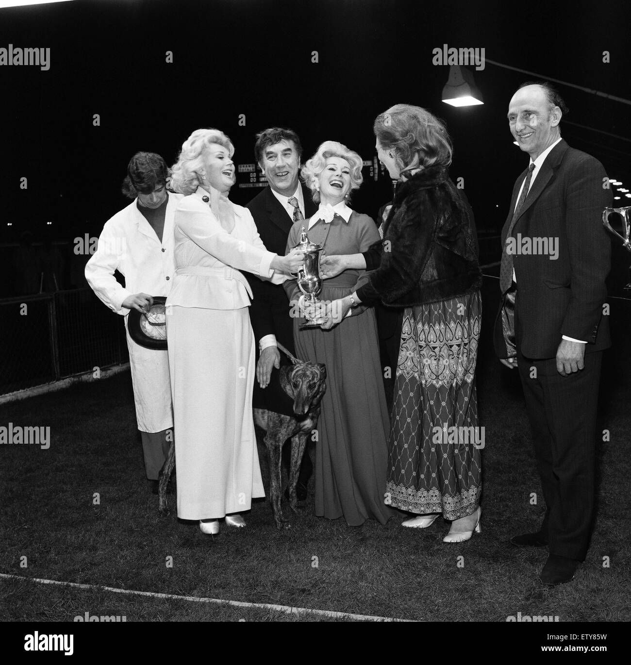 Frankie Howerd, took the two Gabor sisters Eva and Zsa Zsa, out for a different evening's entertainment watching greyhound racing at White City. They all presented Mrs A.A Thompson with the cup for winning the evenings big race with her greyhound 'After t Stock Photo