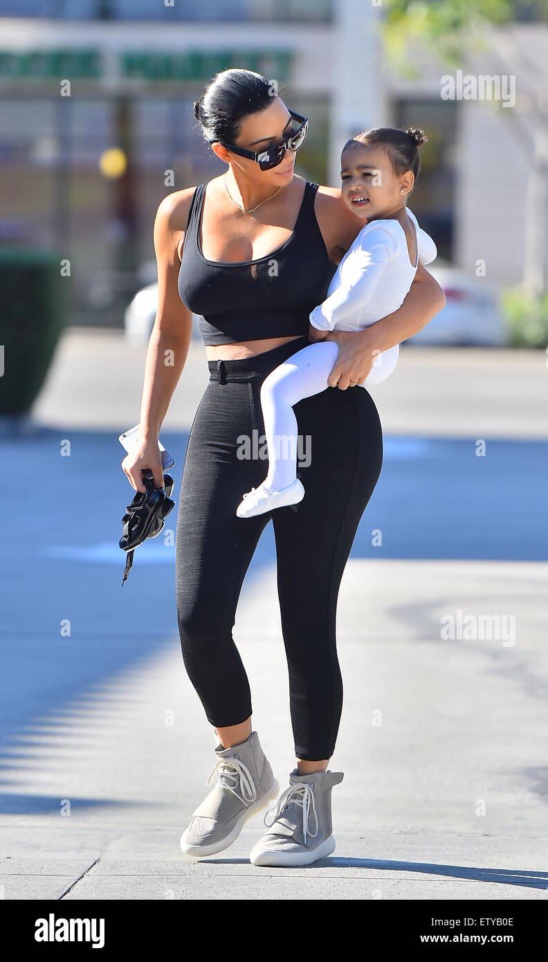 Kim Kardashian is back to black hair as she and Kourtney take their kids to  ballet in Woodland Hills. Kim sporting a pair of Adidas Yeezy Boost  sneakers designed by Kanye West