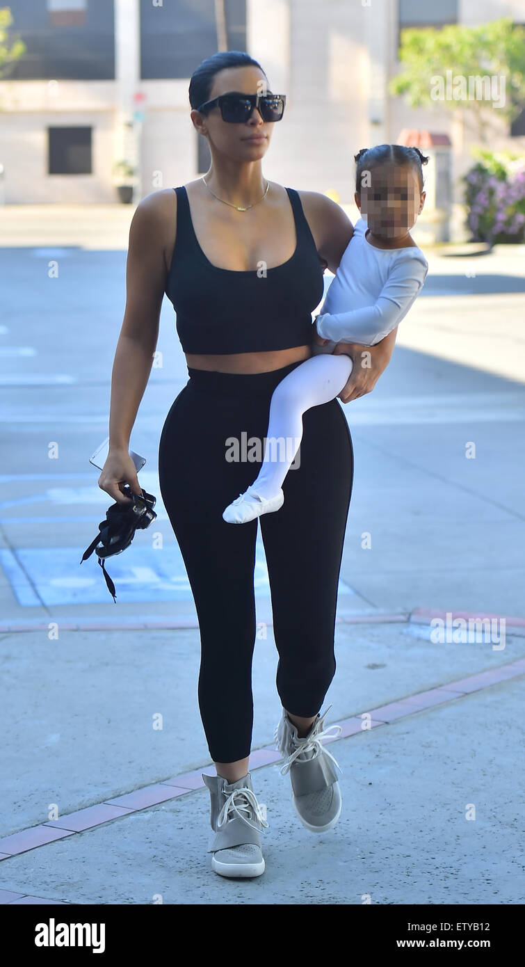Kim Kardashian is back to black hair as she and Kourtney take their kids to  ballet in Woodland Hills. Kim sporting a pair of Adidas Yeezy Boost sneakers  designed by Kanye West