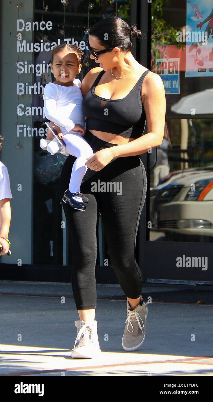 Kim Kardashian is back to black hair as she and Kourtney take their kids to ballet in Woodland Hills. Kim s sporting a pair of Adidas Yeezy Boost sneakers designed by Kanye West