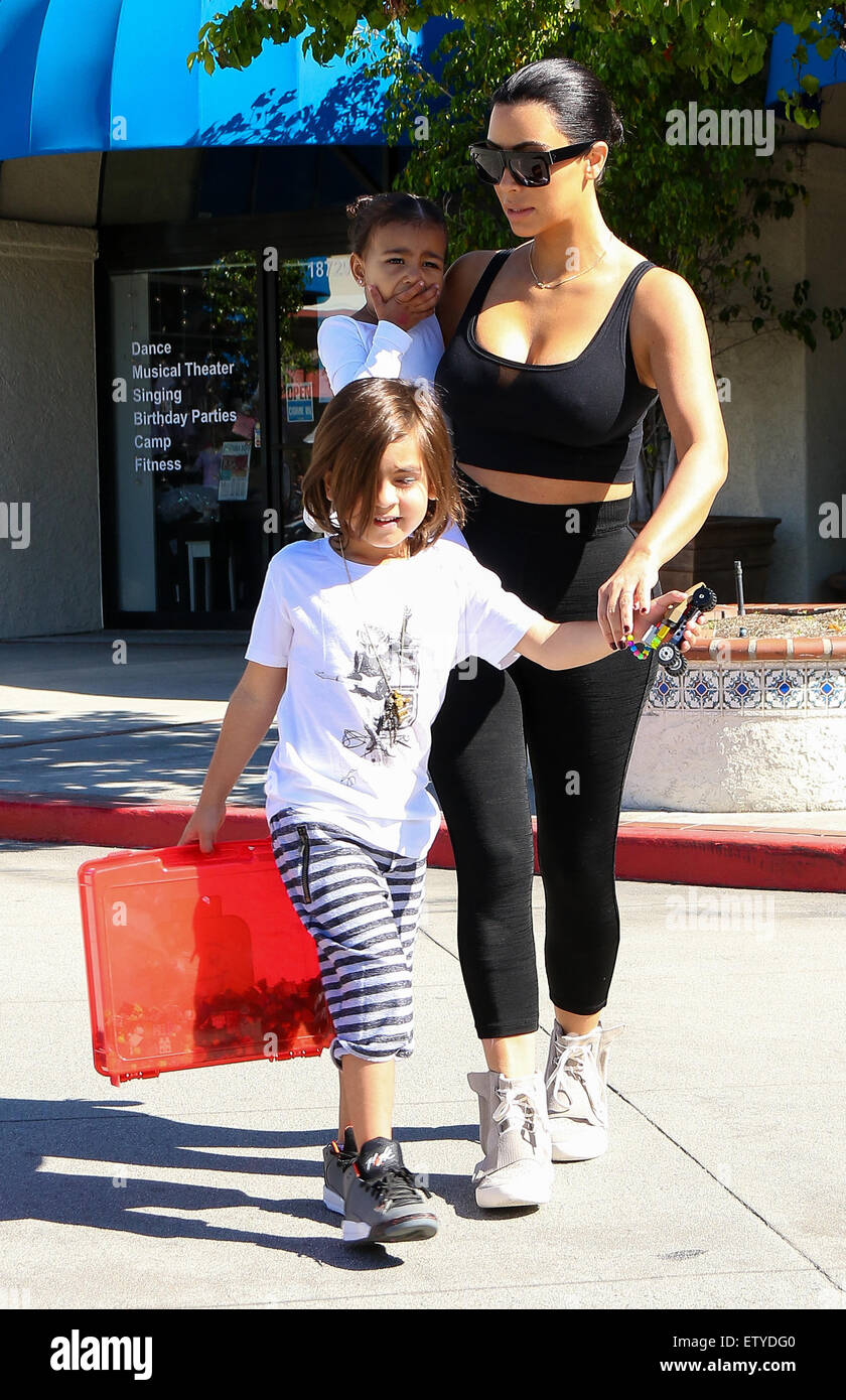 Kim Kardashian is back to black hair as she and Kourtney take their kids to  ballet in Woodland Hills. Kim's sporting a pair of Adidas Yeezy Boost  sneakers designed by Kanye West