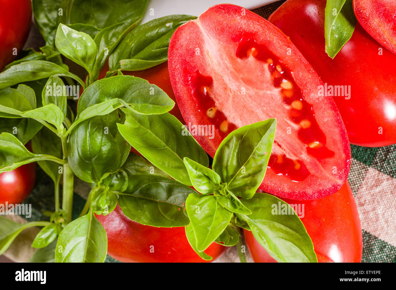 Cut paste tomatoes with basil Stock Photo