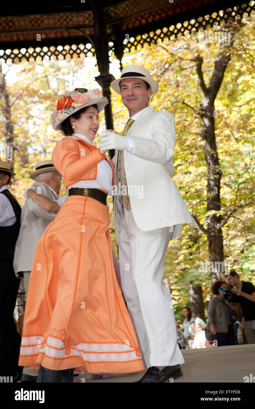 Pair wearing costumes dancing under a porch in the Luxembourg gardens in Paris, France Stock Photo
