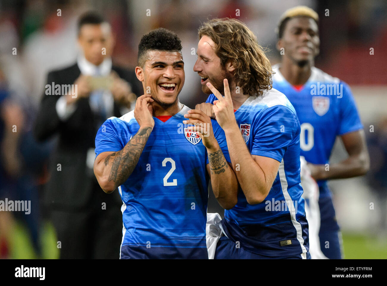 Cologne, Germany. 10th June, 2015. DeAndre Yedlin (L) and Mix Diskerud of the USA celebrate after the international friendly soccer match between Germany and the USA at RheinEnergieStadion in Cologne, Germany, 10 June 2015. The USA won the match 2-1. Photo: Thomas Eisenhuth/dpa - NO WIRE SERVICE -/dpa/Alamy Live News Stock Photo