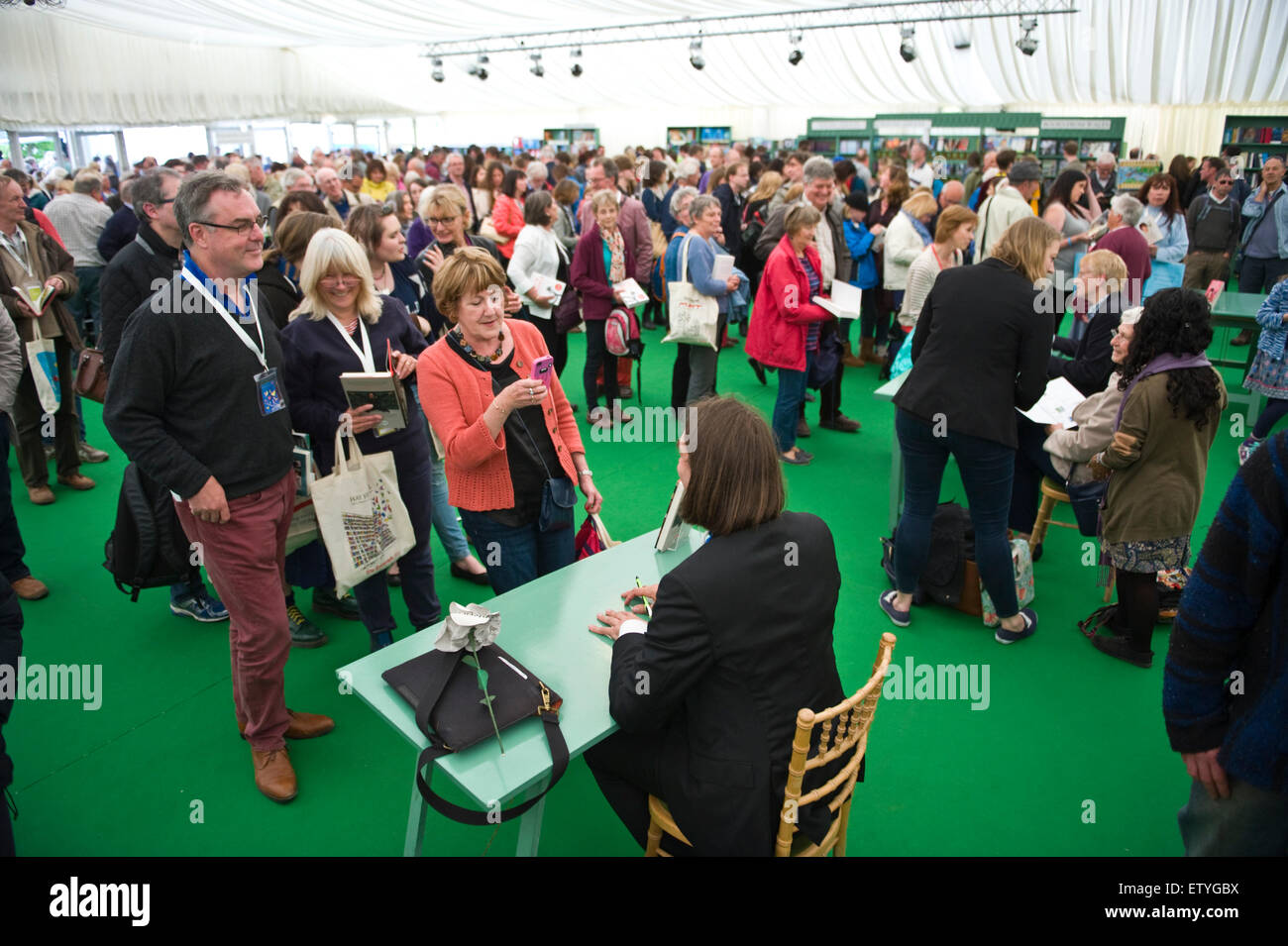 Authors surrounded by crowds of fans book signing in bookshop at Hay Festival 2015 Stock Photo