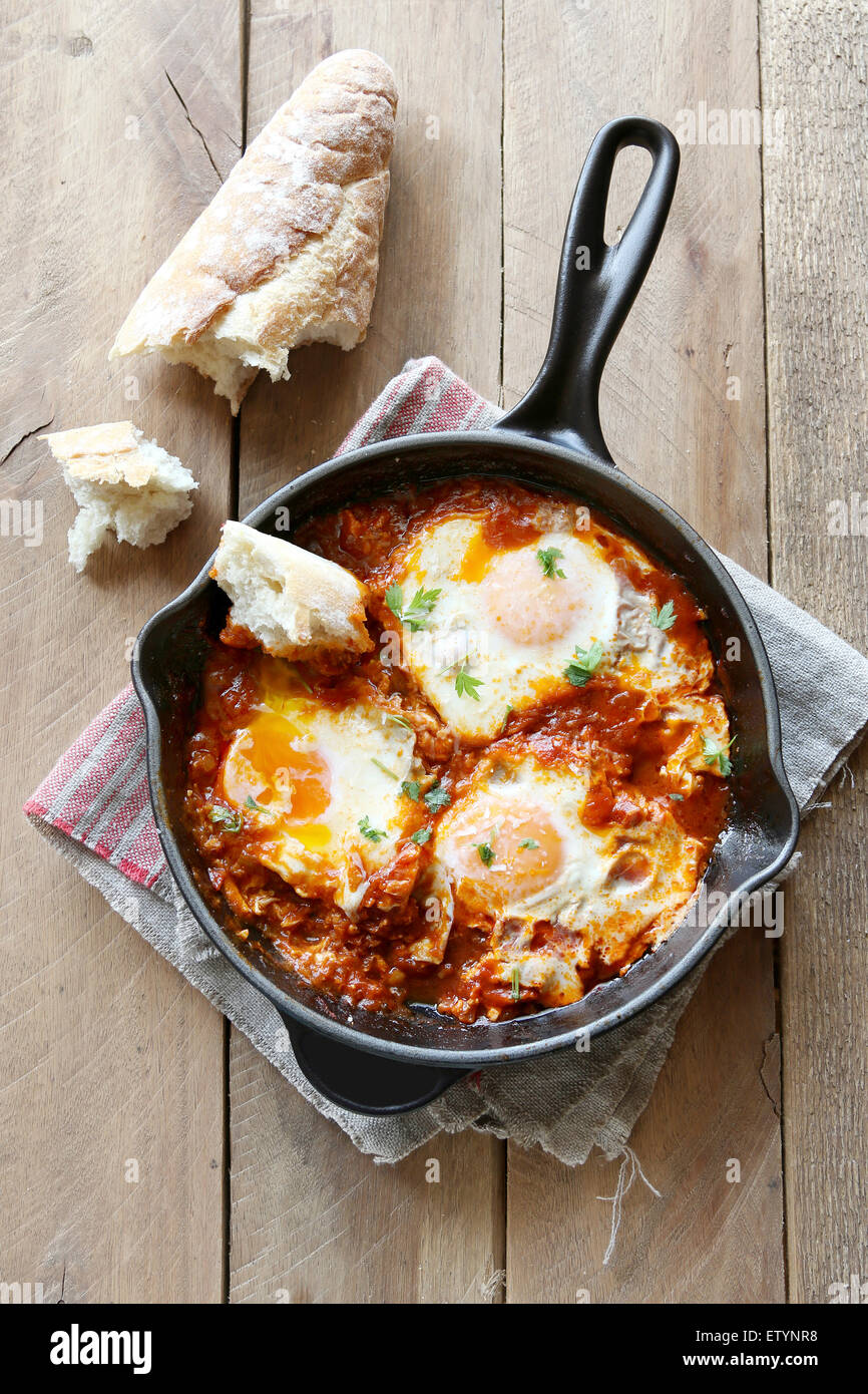 Poached eggs in tomato sauce Stock Photo Alamy