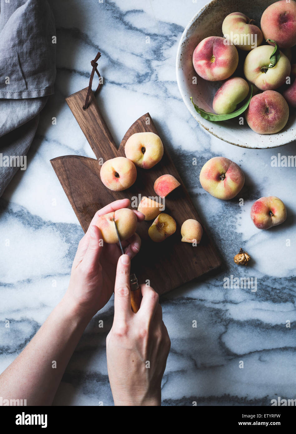 Peaches and chopping board Stock Photo