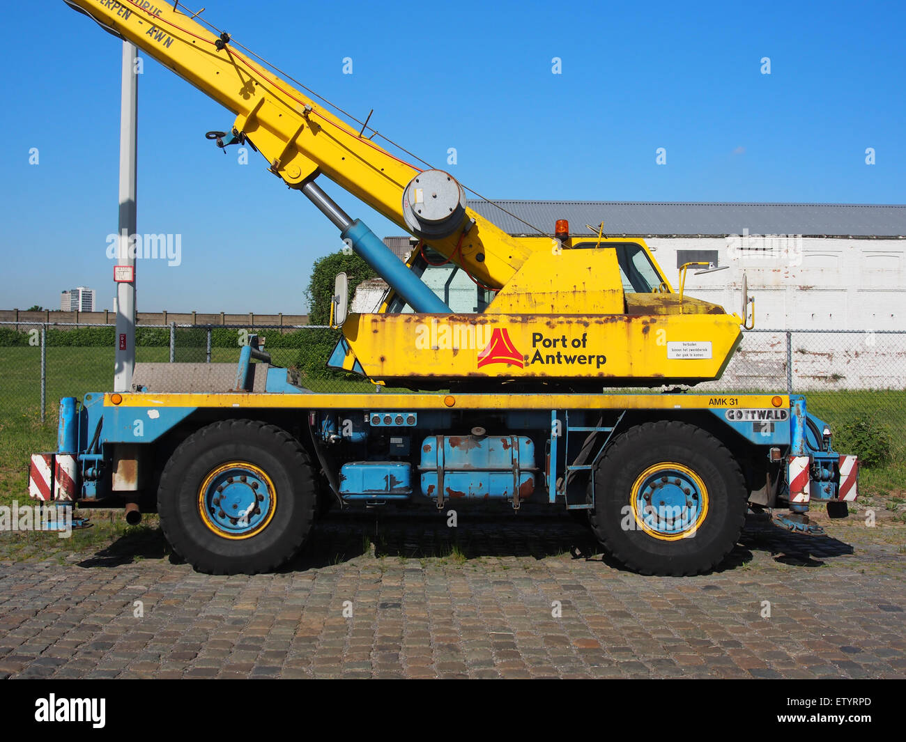 This image depicts a Gottwald crane in action at the Port of Antwerp in 1987. The crane, a critical component of the port's cargo handling operations, showcases the industrial strength and efficiency required for harbor logistics. Stock Photo