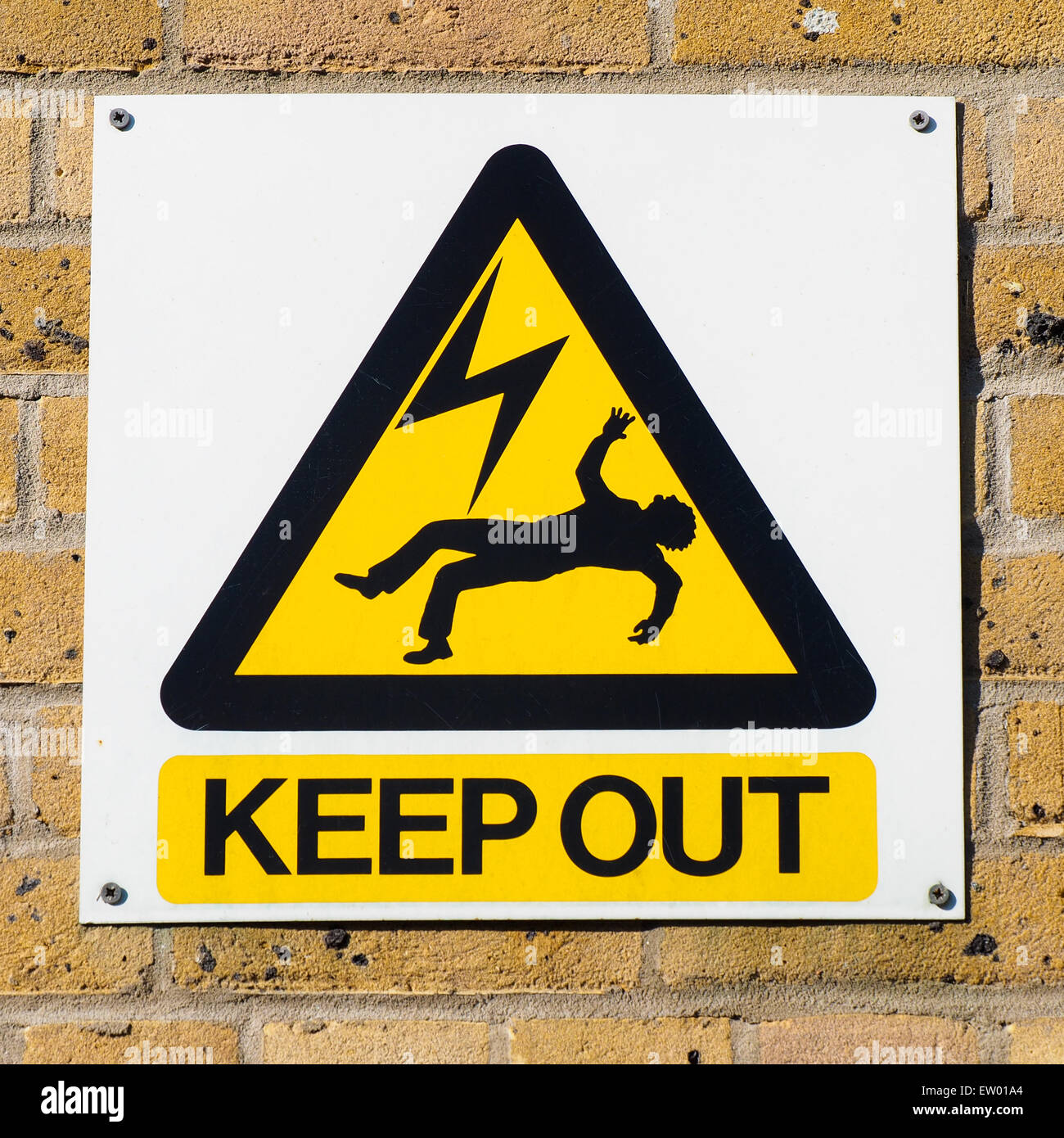 Industrial warning plate in an electricity plant, signaling death danger for high voltage power in the surrounding Stock Photo