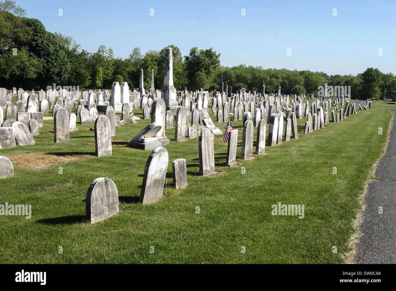 Old tombstones at american cemetery, Forks united church of christ, american flag, Pennsylvania, USA. Stock Photo