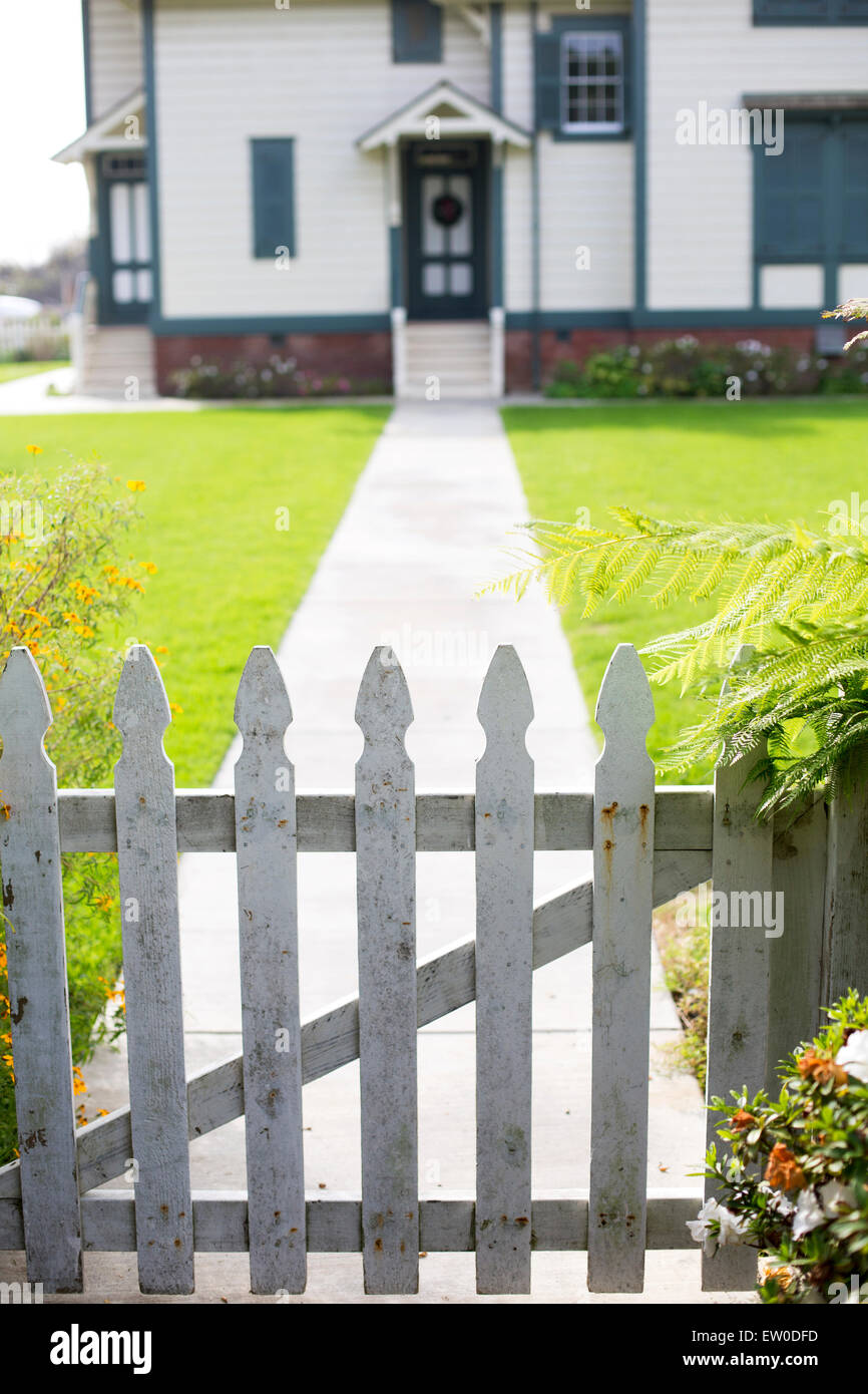 white picket fence and an entrance of a home Stock Photo