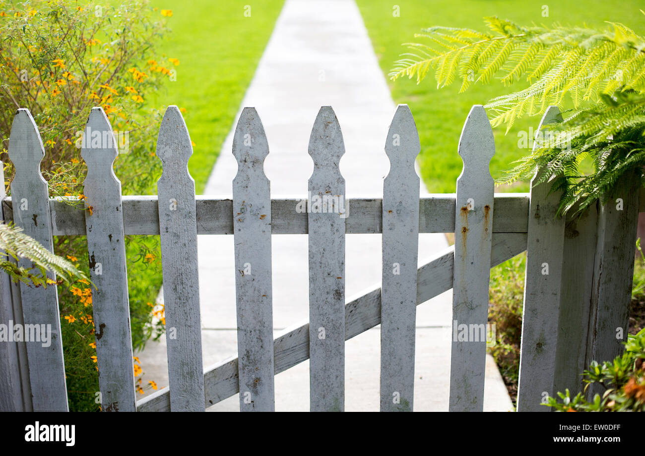 white picket fence and a walkway Stock Photo