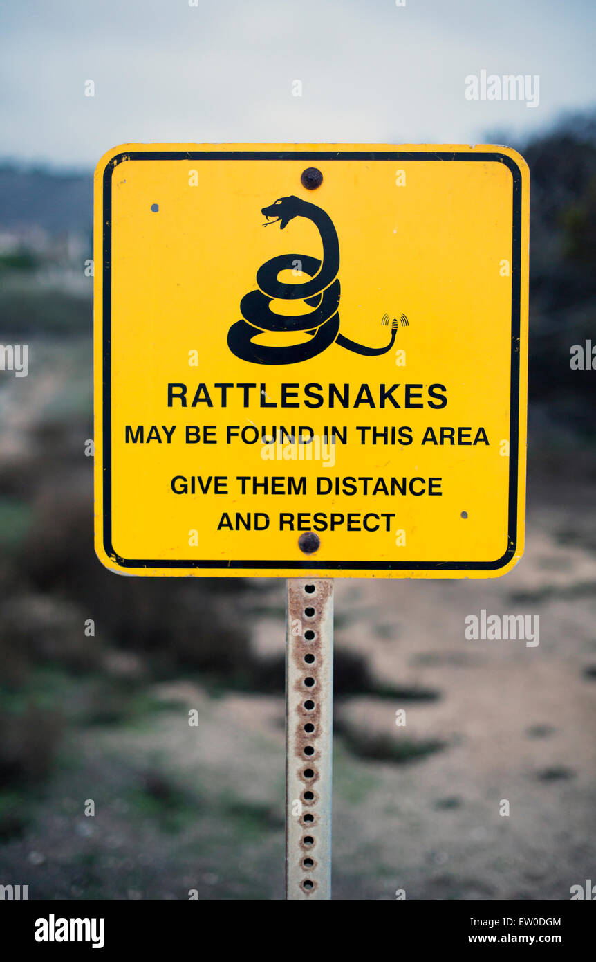yellow sign with a warning for rattlesnakes Stock Photo Alamy