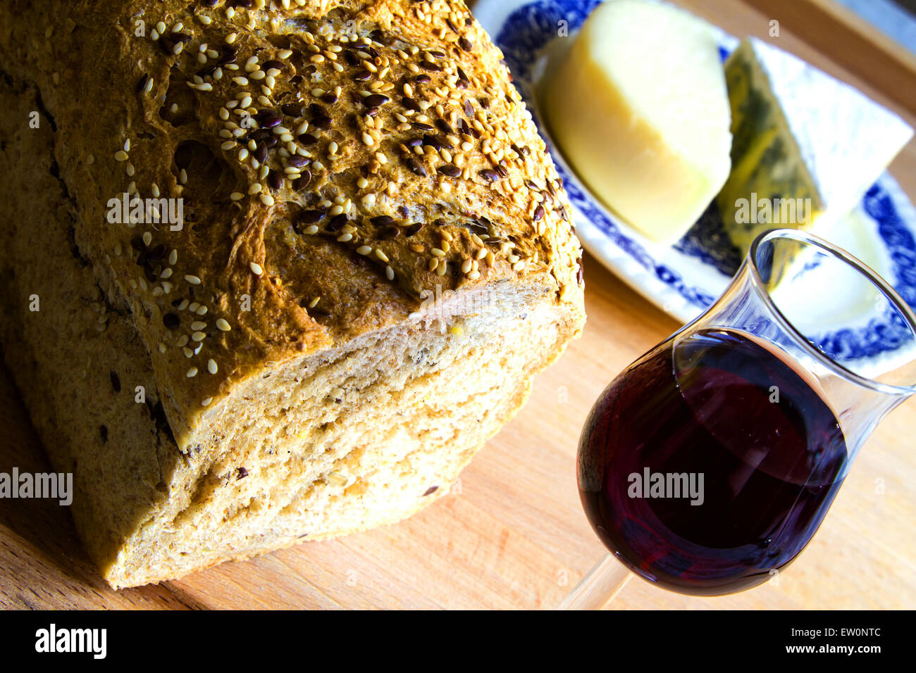 Delicious snack, bread, glass of red wine and cheese Stock Photo