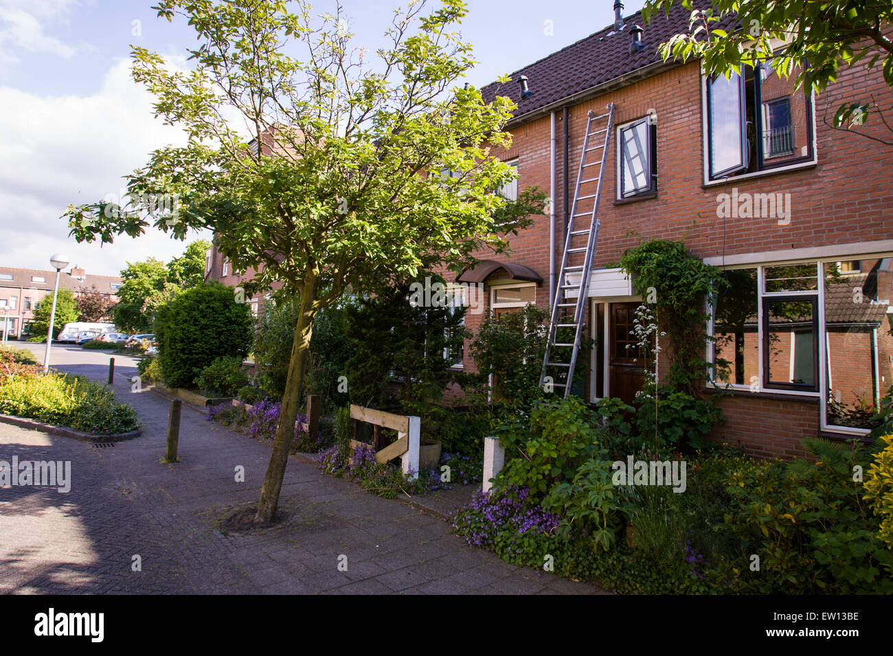 A ladder is seen leaning against a house in a Dutch suburb. Stock Photo