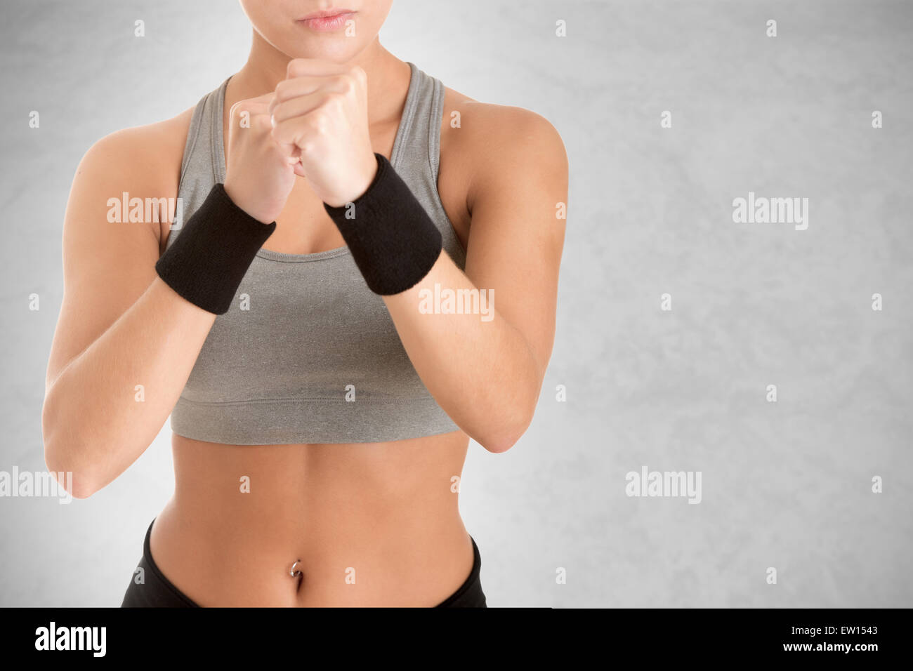 Female Boxer Ready to Fight isolated in grey Stock Photo