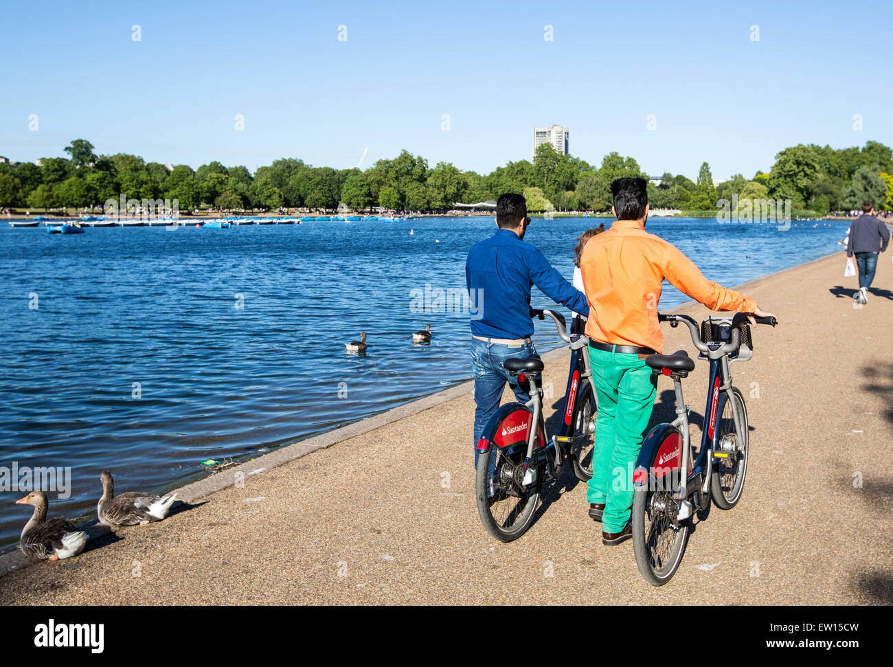 Men Walking With Bicycles Hyde Park London UK Stock Photo