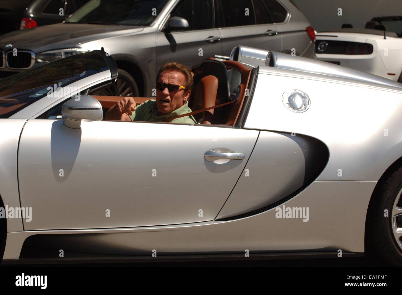 Arnold Schwarzenegger spotted out and about in Beverly Hills in a Bugatti Veyron  Featuring: Arnold Schwarzenegger Where: Los Angeles, California, United States When: 04 Apr 2015 C Stock Photo