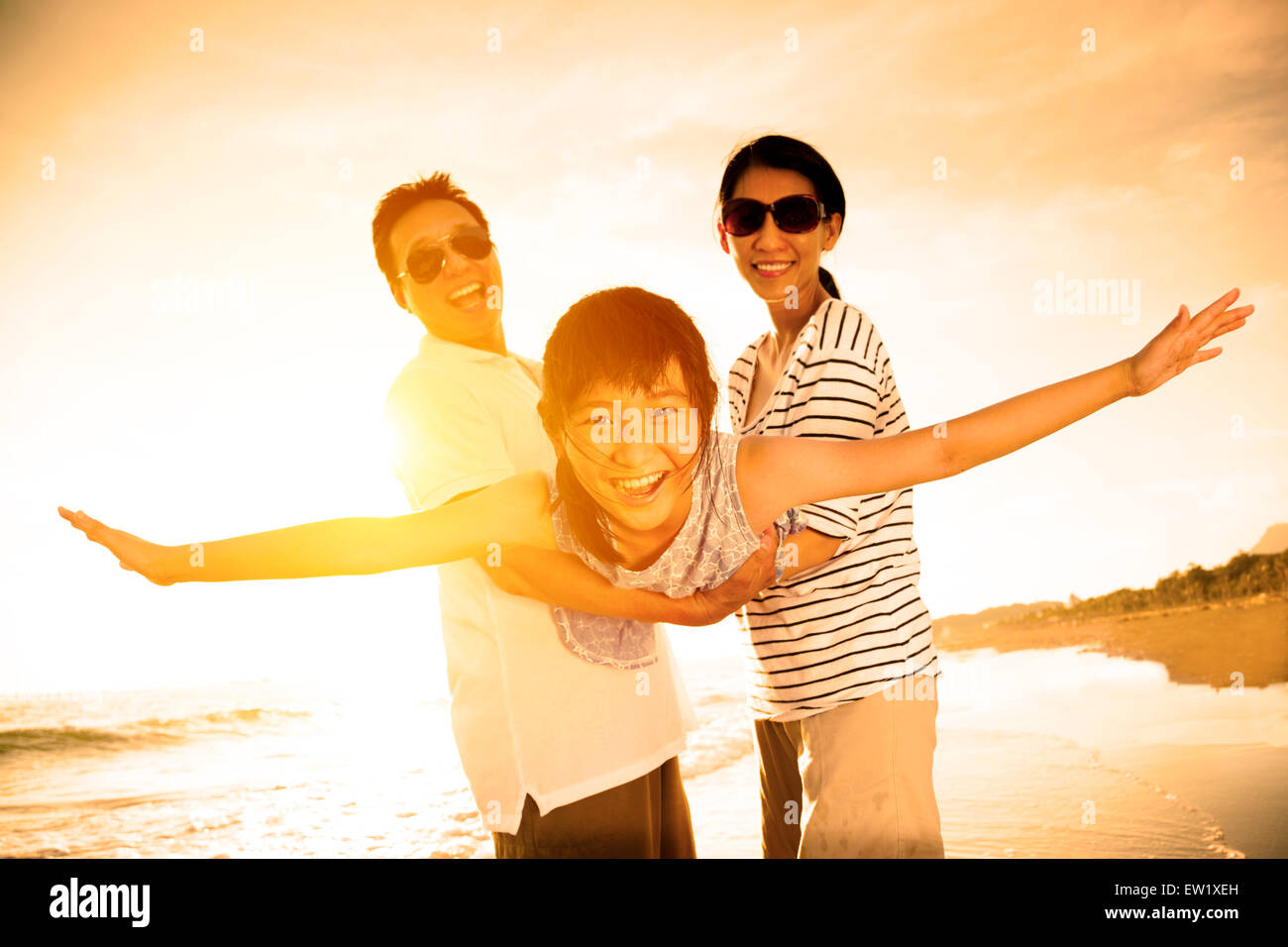 Happy family with daughter on the beach hi-res stock photography and ...