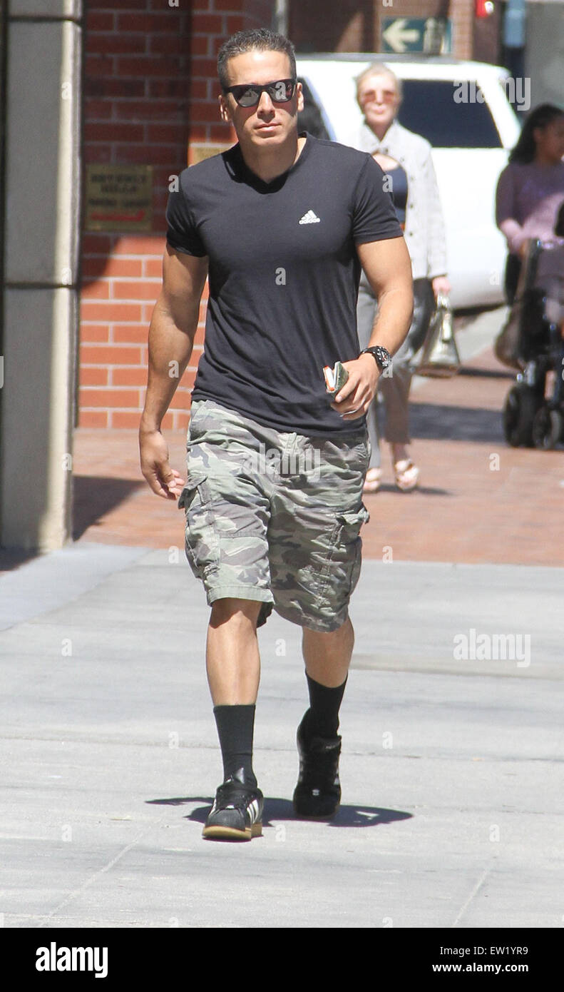 Actor Kirk Acevedo out and about running errands in Beverly Hills wearing  camouflage shorts, long black