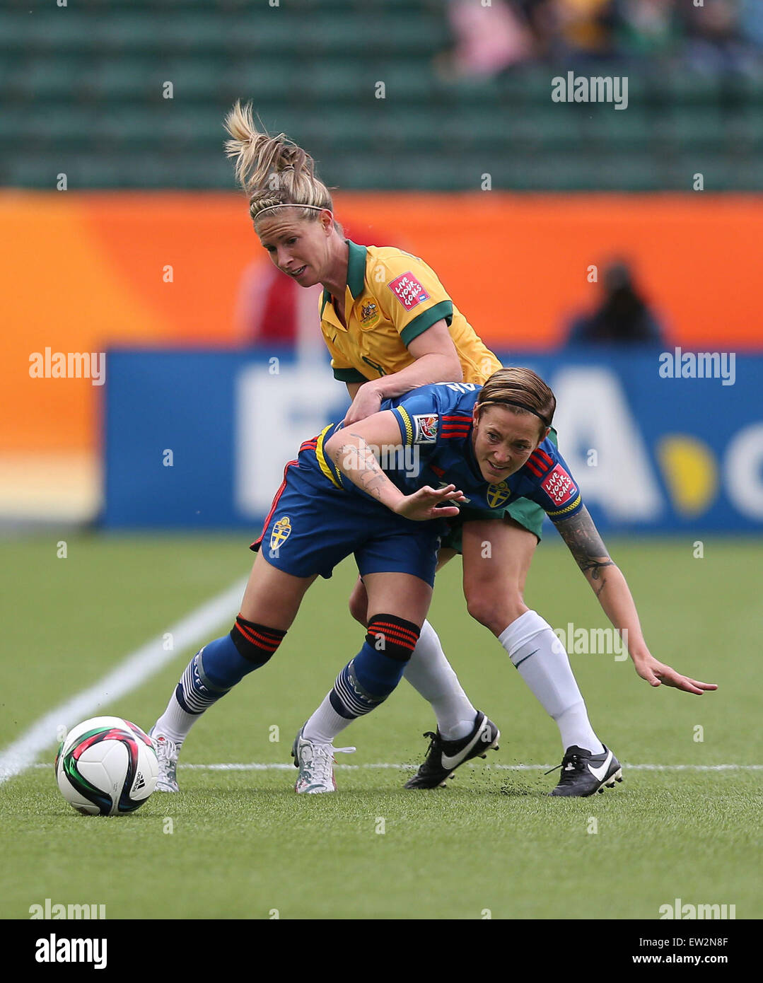 Edmonton, Canada. 16th June, 2015. Lotta Schelin (below) of Sweden vies with Elise Kellond-Knight of Australia during the group D match at the Commonwealth Stadium in Edmonton, Canada, on June 16, 2015. The match ended with a 1-1 draw. Credit:  Qin Lang/Xinhua/Alamy Live News Stock Photo