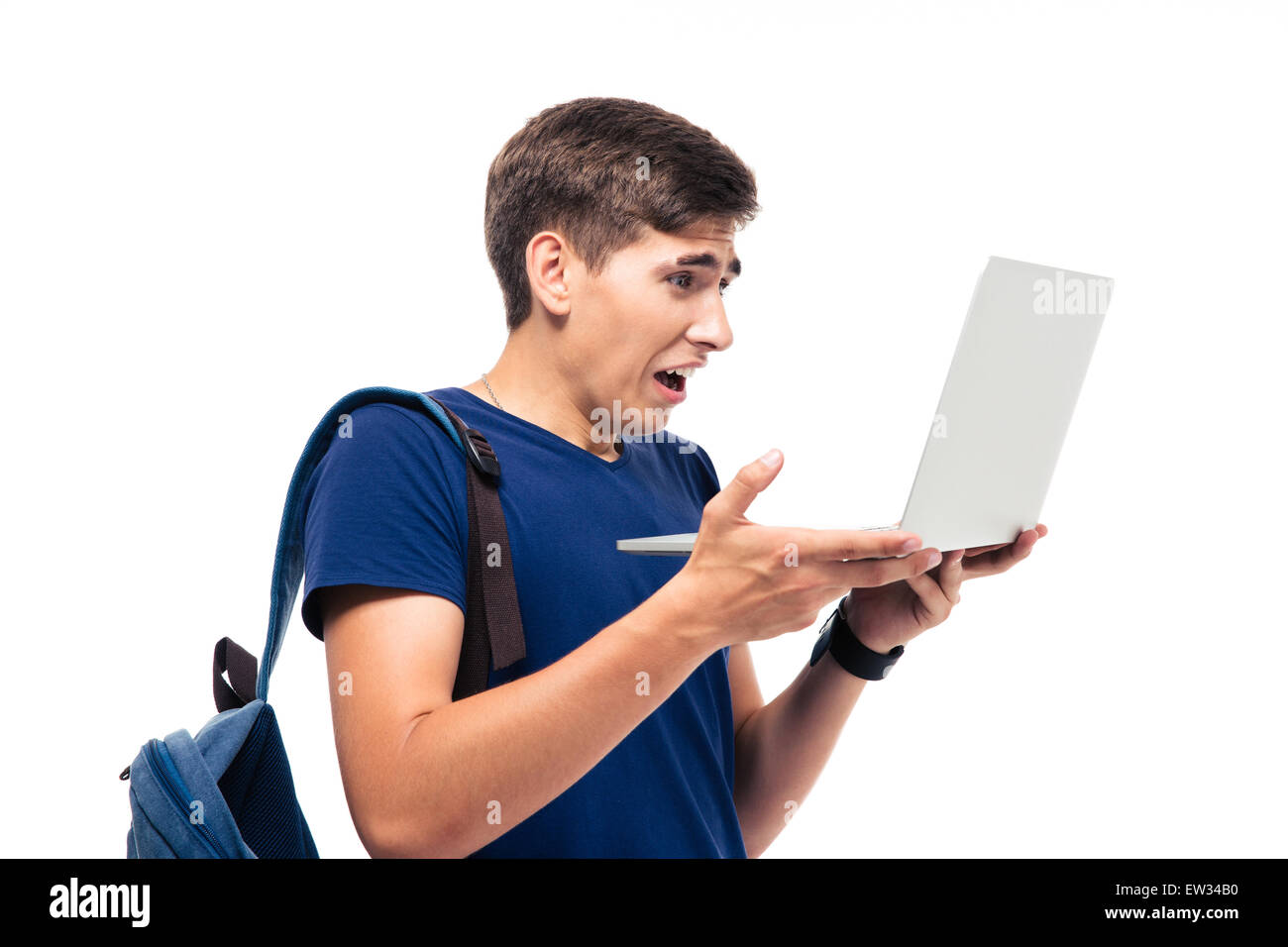 Male student with disgusted emotion holding laptop isolated on a white background Stock Photo