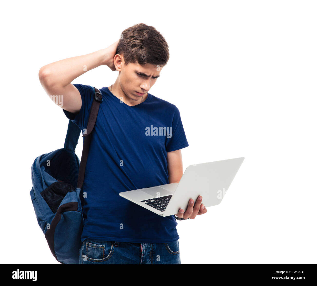 Pensive male student holding laptop isolated on a white background ...