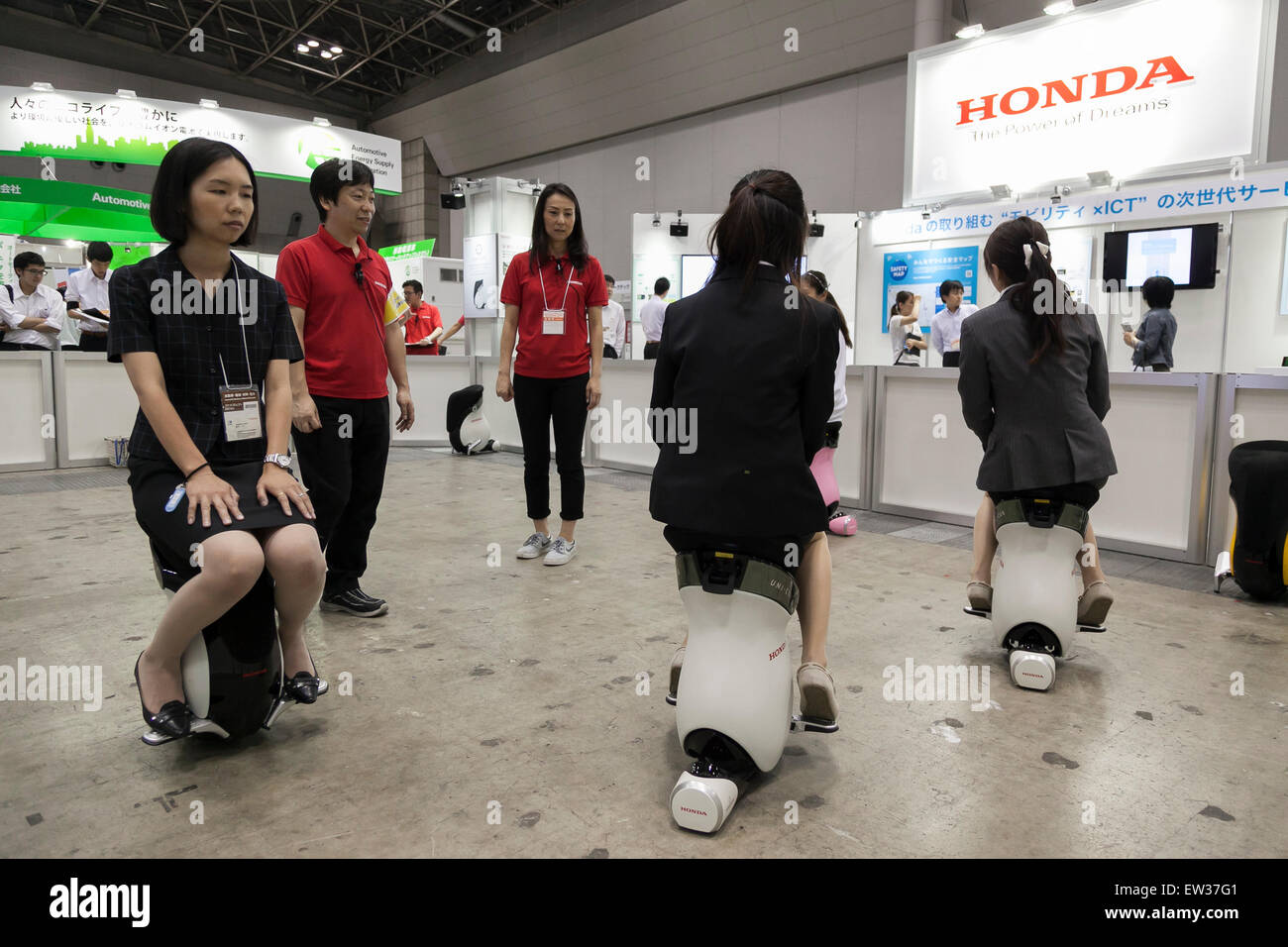 Tokyo, Japan. 17th June, 2015. An exhibitor and visitors drive a personal mobility device ''UNI-CUB'' at the Smart Community Japan 2015 in exhibition in Tokyo, Big Sight on June 17, 2015, Tokyo, Japan. The exhibition promotes both domestic and overseas next-generation technologies. The last year 39,879 visitors attend the expo during three days. This year 233 enterprises and organizations will show their products from June 17th to 19th. Credit:  Rodrigo Reyes Marin/AFLO/Alamy Live News Stock Photo