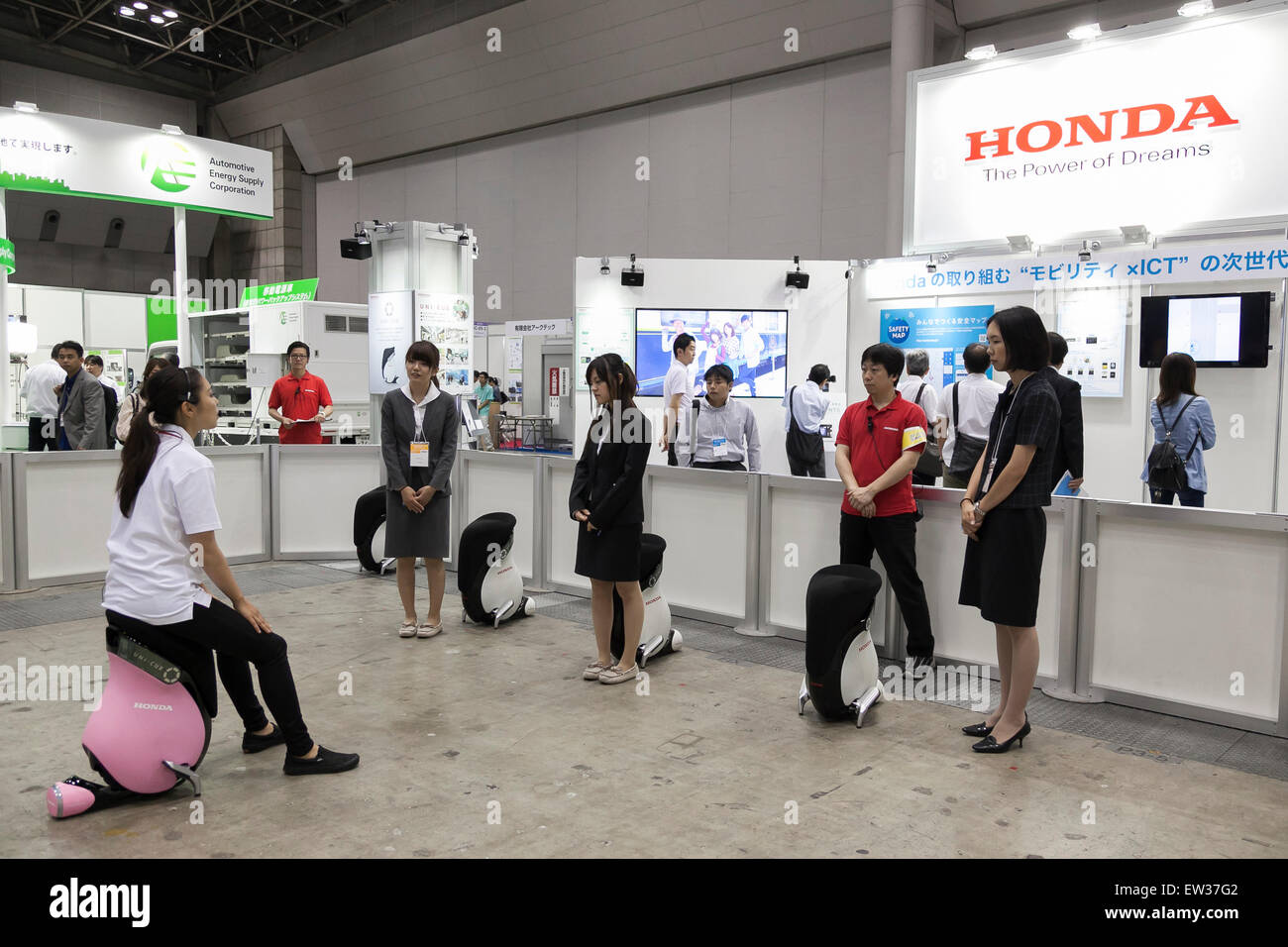 Tokyo, Japan. 17th June, 2015. An exhibitor shows to visitors how to drive a personal mobility device ''UNI-CUB'' at the Smart Community Japan 2015 in exhibition in Tokyo, Big Sight on June 17, 2015, Tokyo, Japan. The exhibition promotes both domestic and overseas next-generation technologies. The last year 39,879 visitors attend the expo during three days. This year 233 enterprises and organizations will show their products from June 17th to 19th. Credit:  Rodrigo Reyes Marin/AFLO/Alamy Live News Stock Photo