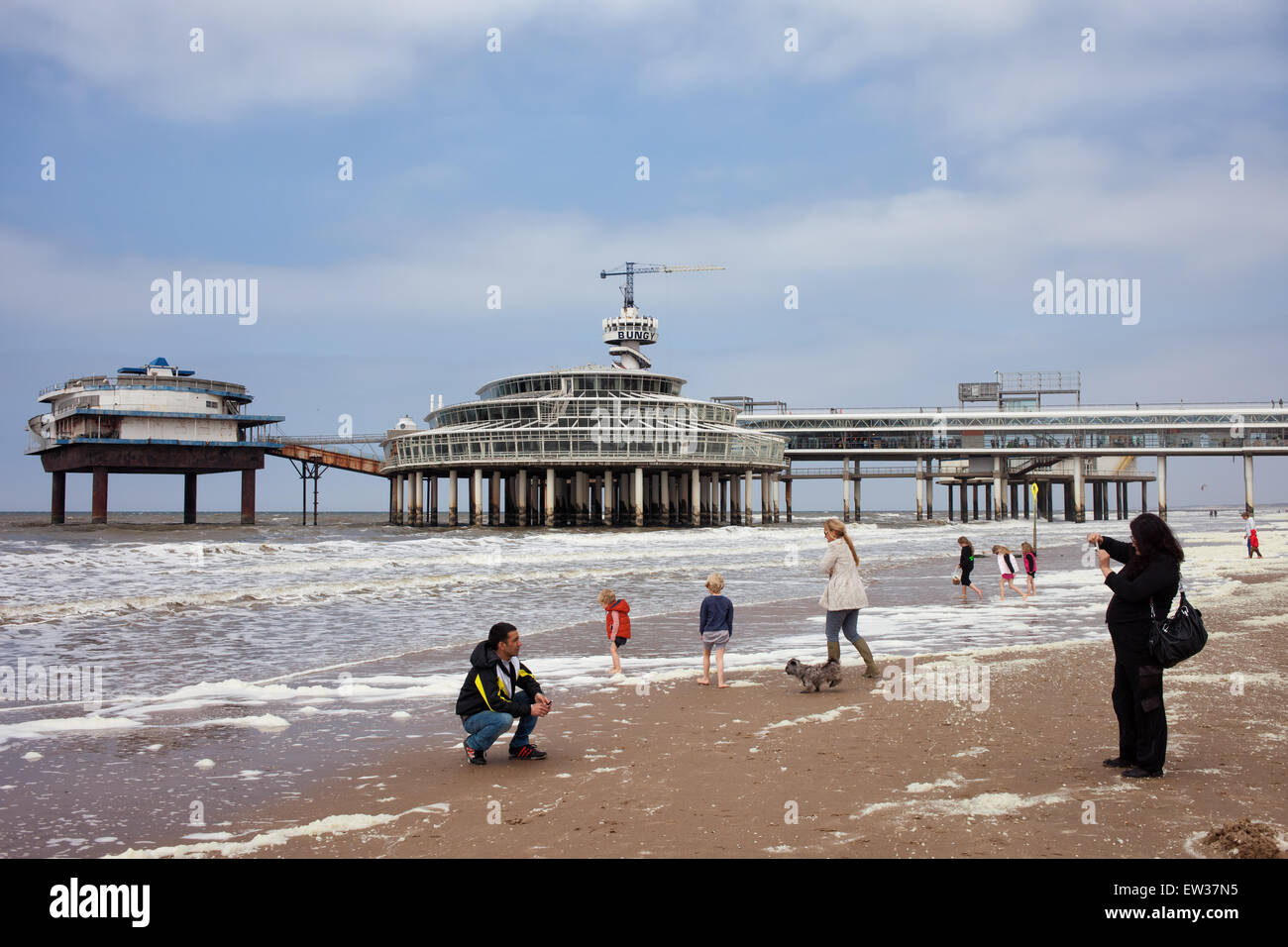 People on Scheveningen beach and pier by the North Sea in The Hague (Den Haag), South Holland, the Netherlands. Stock Photo