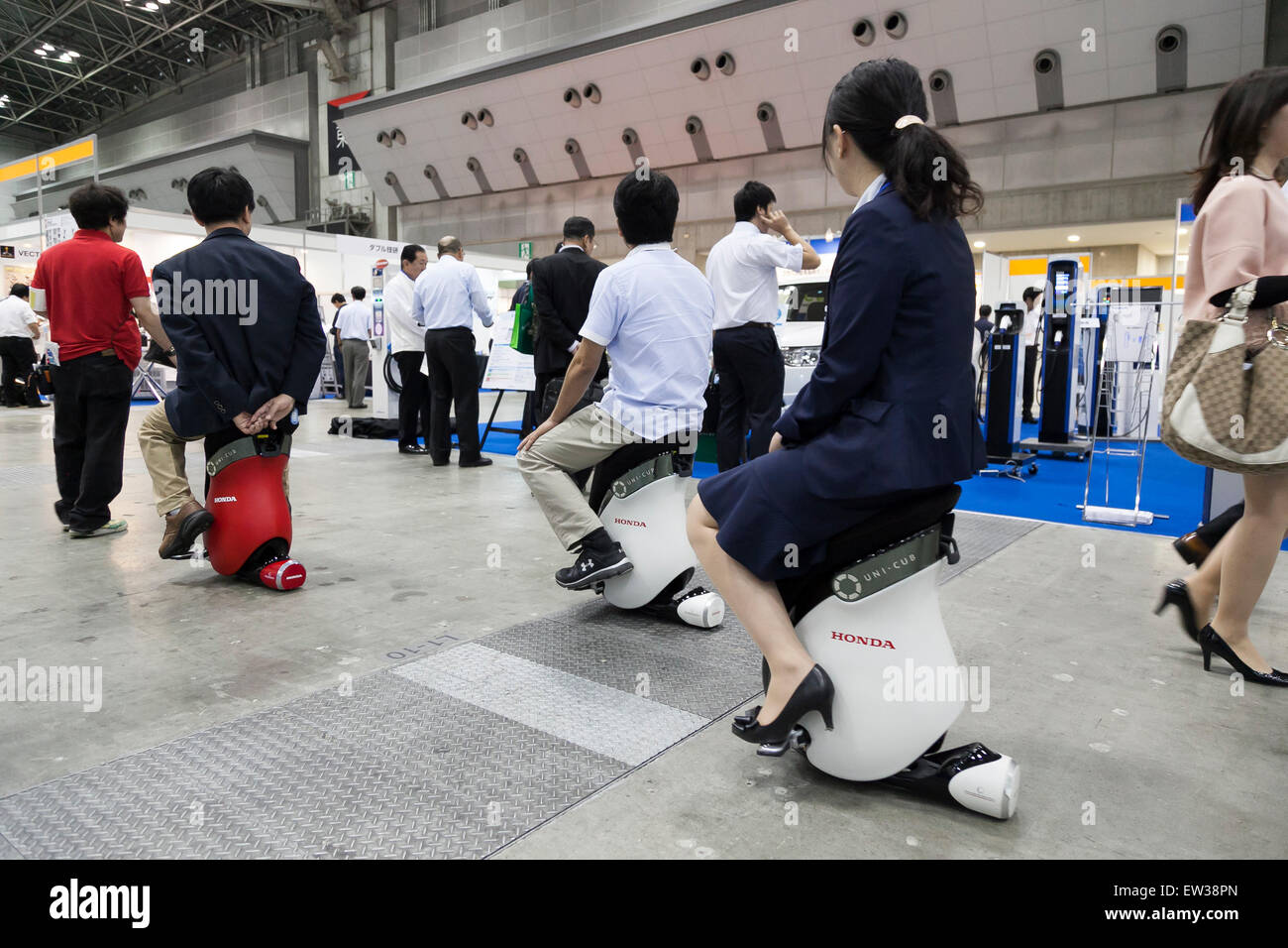Tokyo, Japan. 17th June, 2015. Visitors drive a personal mobility device ''UNI-CUB'' at the Smart Community Japan 2015 in exhibition in Tokyo, Big Sight on June 17, 2015, Tokyo, Japan. The exhibition promotes both domestic and overseas next-generation technologies. The last year 39,879 visitors attend the expo during three days. This year 233 enterprises and organizations will show their products from June 17th to 19th. Credit:  Rodrigo Reyes Marin/AFLO/Alamy Live News Stock Photo