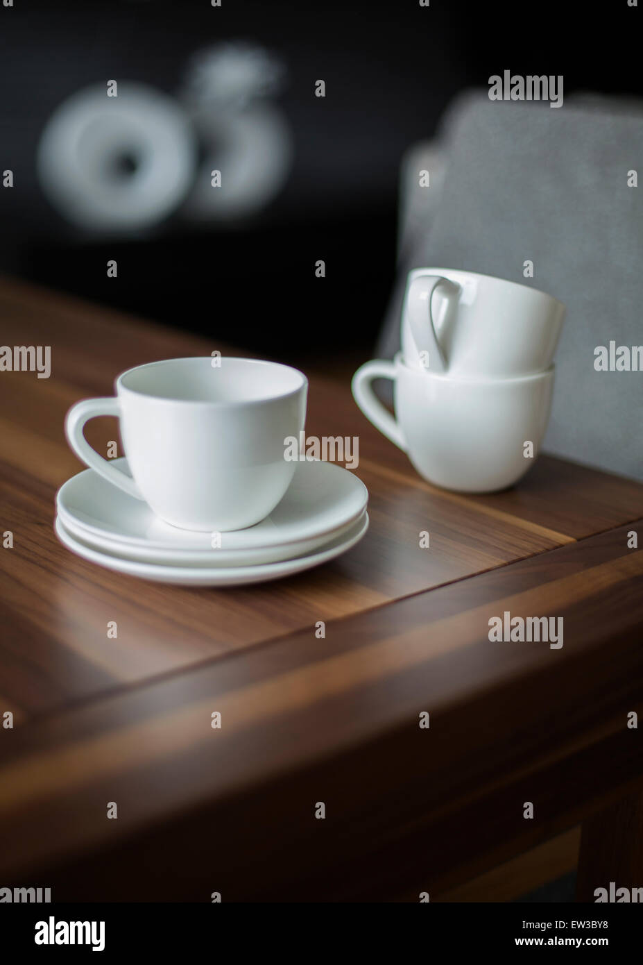 closeup of white porcelain cups on a wooden table Stock Photo