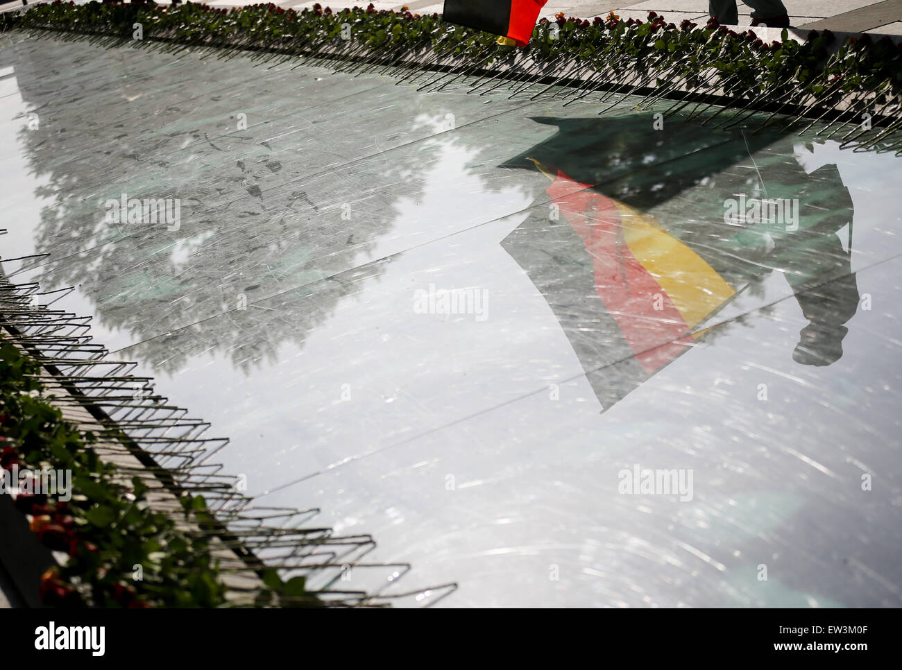 Berlin, Germany. 17th June, 2015. A flag is reflected in the glass of the memorial in front of the Finance Ministry at the site of the people's revolt in Berlin, Germany, 17 June 2015. 62 years ago over one million people took to the streets in around 700 GDR locations. The revolt was defeated with tanks from the Soviet occupying forces. Photo: KAY NIETFELD/dpa/Alamy Live News Stock Photo
