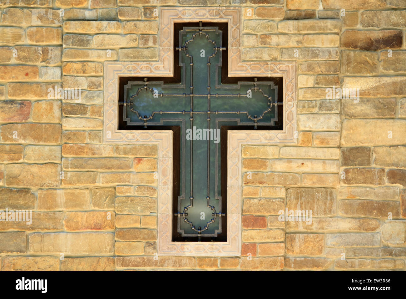 decorative metal cross on textured wall Stock Photo Alamy